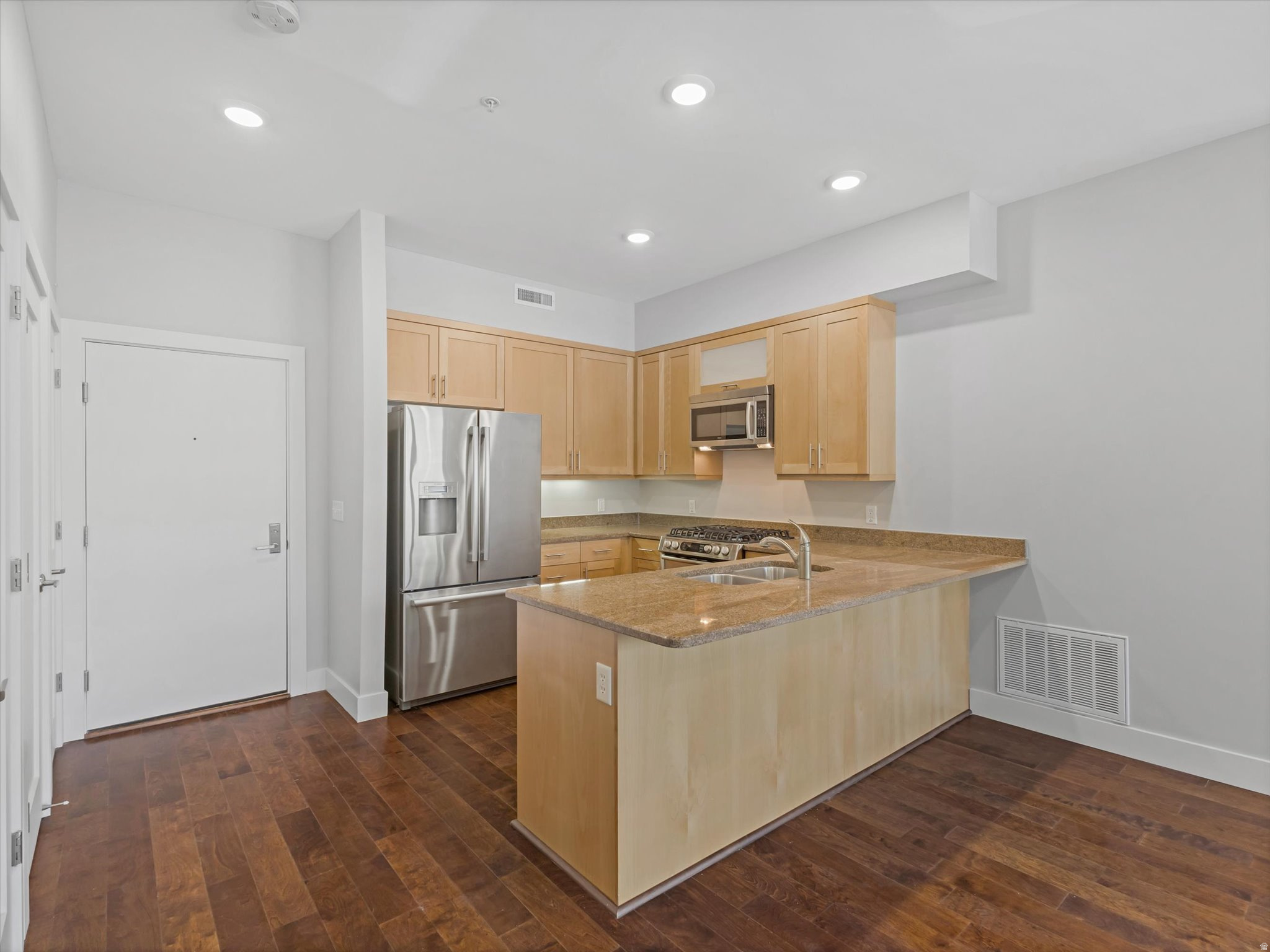 Rarely available and located on a tree-lined street in the heart of highly walkable Sugar House. Your new lifestyle will include walks around the park with a quick stop at Whole Foods, evenings on the patio at neighborhood restaurants, streetcar rides to the airport and quick freeway access. This condo is stylish and full of premium features. It offers tall ceilings, beautiful wood floors, oversized windows, a large kitchen with granite counters and bar seating, Bosch range, updated bath with jetted tub and separate shower, gas fireplace, and two private balconies. The common area is an expansive 4th-floor balcony with a hot tub, grill, patio and stunning Wasatch Mountain views. Urbana is well run with low dues. Great location, updates, and value!