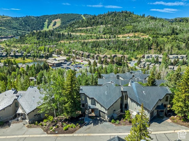 Discover the perfect blend of comfort, elegance, and location in this spacious 4-bedroom Pinnacle townhome, ideally situated in the coveted heart of Deer Valley. Designed with timeless appeal and effortless entertaining in mind, this home boasts a sought-after downhill floor plan and expansive, light-filled living spaces. Soaring vaulted ceilings and wall-to-wall windows in the great room frame panoramic mountain views, while flooding the space with natural light. The open-concept dining and living area flows seamlessly to multiple gathering zones-including a billiards room with a wet bar, a cozy lower-level den, and generous outdoor decks-offering plenty of room for large groups or multiple families to unwind and connect. A private hot tub adds the perfect finishing touch for relaxing aprs-ski evenings. Whether you're searching for a tranquil mountain retreat or a high-performing vacation rental, this townhome delivers on all fronts. Located just minutes from world-renowned skiing, scenic hiking trails, and award-winning dining, this is a rare opportunity to own in one of Deer Valley's most prestigious communities.