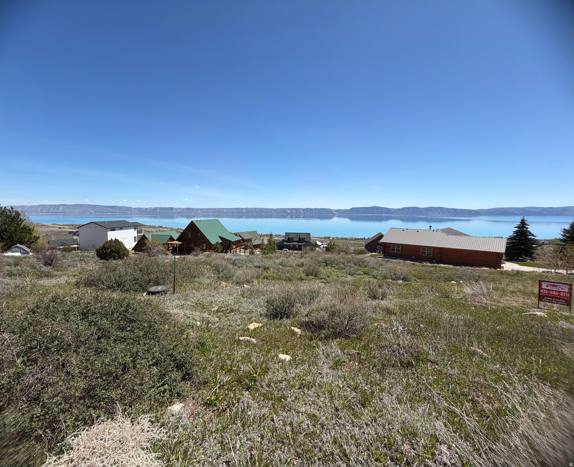 What an amazing view of Bear Lake, the valley and mountains. The fall colors are always breath taking . When you complete your dream home you can sit on your deck and watch the sunrise while you enjoy breakfast at your happy place. Bear Lake has always provided opportunities  for relaxation, water adventures whether you enjoy fishing or boating, water skiing.  Make this lot your landing spot.