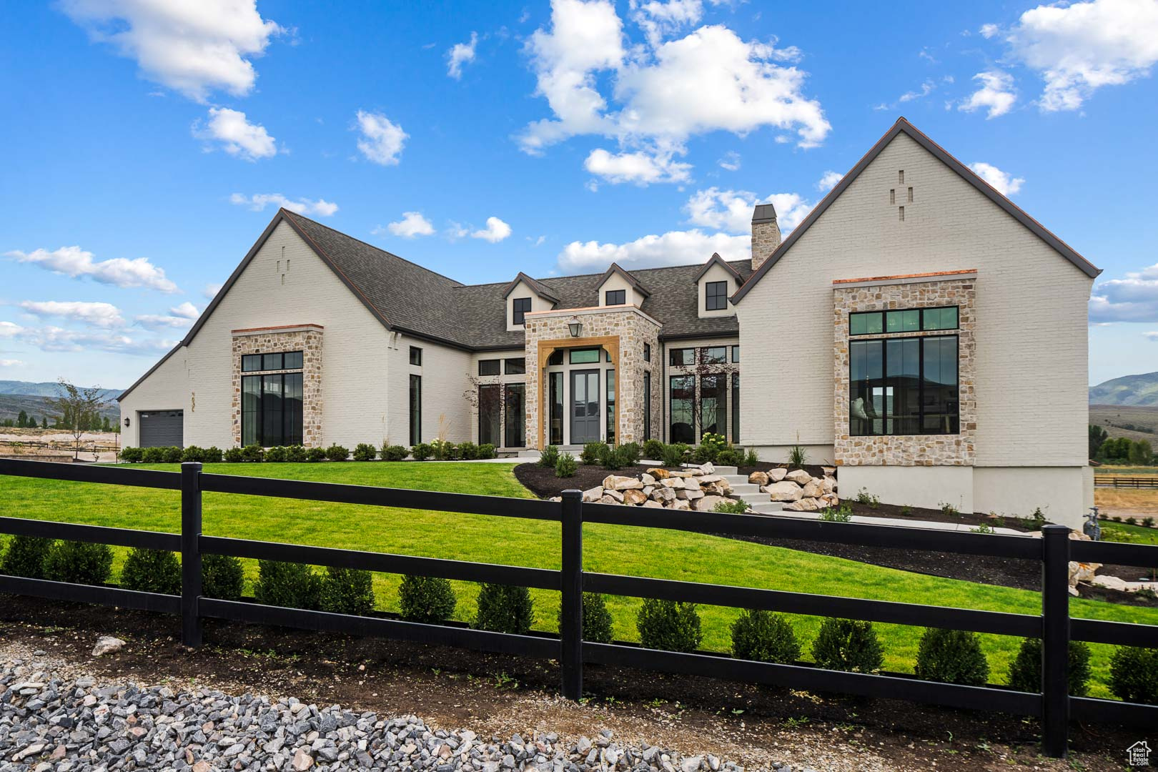 Nestled in the heart of Heber City, this newly constructed dream home is a stunning example of European-inspired transitional design-where timeless elegance meets modern functionality. The home features steep gabled rooflines, elongated windows echoing traditional European country design, and a sophisticated blend of stone, brick, and smooth stucco. Inside, the open-concept floor plan is bright and welcoming, with expansive rear-facing windows that capture panoramic views of the surrounding mountains and meadow. The main level includes a beautiful chef's kitchen alongside dining and lounge space, all designed for effortless entertaining. The master suite is a true retreat, with walls of windows that frame the natural scenery. Downstairs, the walkout level is all about creating memories-featuring a spacious media room, a designated workout space, kids' play zone, golf simulator, and a luxurious spa complete with a sauna, cold plunge, and heated stone bed. Multiple outdoor living spaces, including a covered patio and a resort-style swimming pool, make the most of the home's sloped lot and serene setting. This estate blends European grandeur with thoughtful modern design, offering a perfect balance of sophistication, comfort, and year-round livability. Situated on a 1-acre lot in Meadow Views Subdivision, this fully landscaped property captures sweeping valley and mountain views.  Come see this incredible home in person-or visit us during the 2025 Park City Showcase, where it will be one of the featured properties.