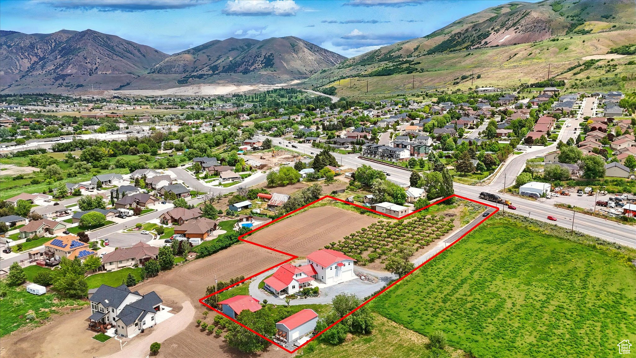 This large home is something very amazing and unique with no element overlooked. The owners went all out on this refurbished historic home, keeping a balance of the original charm and detail work but adding quality modern amenities. The lot has  2.75 acres, large garden open space, large peach tree orchard, and 10 shares of water rights. Outside you will enjoy great mountain views to the east and beautiful sunsets to the west.  Inside boasts main floor living with 5 beautiful bedrooms and 3 1/2 bathrooms. The spacious primary suite located on the main floor has its own bathroom, laundry, and garage access.  . Large open kitchen and formal dining area. Lots of storage spaces throughout. There is a large living area above the garage for all kinds of uses. The area has a full kitchen, bathroom, bedroom and large open area, perfect for an ADU, gatherings, work, the possibilities are limitless. The oversized garage is fully finished, has a thermostat controlled heater. The 11' tall doors on the pull through garage is a perfect amenity to this huge garage. There is a detached shop for tinkering in or storing things. The detached living unit is approximately 600 sq.' with kitchen, heating and AC is perfect for an ADU, man cave, she shed, or a detached office/work area. (included in home data)