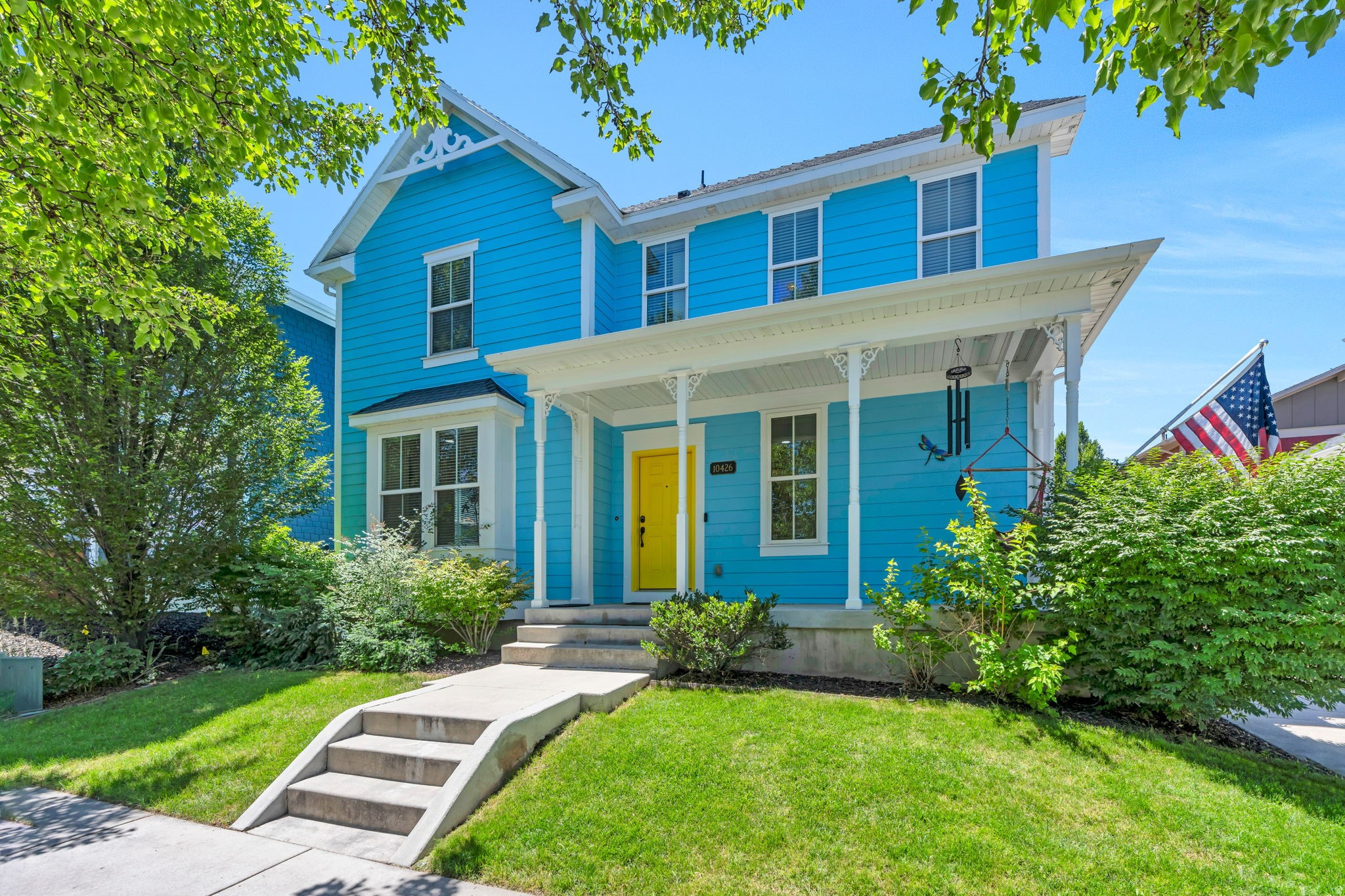 Welcome to this charming Victorian-inspired two-story home in the heart of Daybreak, featuring timeless curb appeal and a welcoming large front porch perfect for relaxing and enjoying the neighborhood.  Inside, the spacious great room offers a cozy fireplace and chic lighting that creates an inviting atmosphere for everyday living and entertaining. The kitchen is beautifully appointed with knotty alder cabinetry, granite countertops, and black appliances, along with convenient access to the back paved patio, complete with a fire pit for outdoor gatherings.  Upstairs, you'll find a generous laundry room with washer and dryer included for added convenience. The primary suite provides a peaceful retreat with an ensuite bathroom featuring a large soaking tub, separate water closet, and walk-in closet designed for comfort and functionality.  Downstairs, the home features a dedicated theater room complete with a projector and screen, making movie nights at home an unforgettable experience.  Ideally located within walking distance to four nearby parks, including Water Tank Park and Willoughby Park. This home offers easy access to green space, trails, and all the incredible amenities Daybreak is known for, including lakes, pools, community events, and miles of walking and biking paths.  This home blends charm, comfort, and an unbeatable location in one of Utah's most desirable master-planned communities.