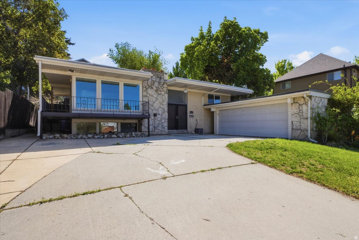 Welcome Home. Step inside this charming Cottonwood Heights gem. The moment you enter, you'll notice the bright and open newly updated Kitchen and Family Room, creating the perfect open-concept living space that truly serves as the heart of the home. The Kitchen has been thoughtfully updated with white cabinetry, Quartz countertops, stainless steel appliances, and stylish pendant lighting. Enjoy cozy evenings by the fireplace while cooking, entertaining, and gathering with family and friends. Built in 1965, this home blends inviting mid-century architecture with the modern updates today's buyers expect. Featuring 4 bedrooms, 3 bathrooms, and a fully finished basement, there is space for everyone to enjoy. The daylight walk-out basement with a spacious second Family Room with large picture windows, a second fireplace, providing flexible living options. Step outside and unwind in the private, lush backyard. The spacious patio, garden boxes, mature trees, and established landscaping create an exceptional outdoor retreat perfect for entertaining and everyday living. Ideally located just minutes from Big Cottonwood Canyon, world-class ski resorts, hiking and biking trails, shopping, dining, and highly regarded schools, this home offers the perfect combination of comfort, convenience, and access to outdoor lifestyle living.  Square footage figures are provided as a courtesy estimate only and were obtained from County .  Buyer is advised to obtain an independent measurement.