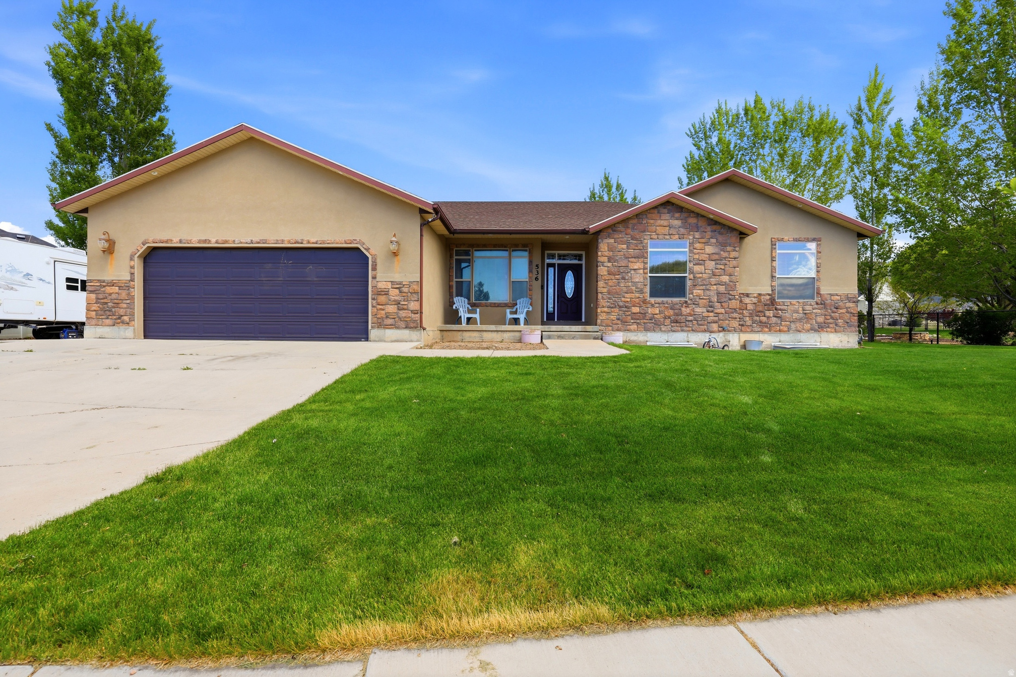 Spacious, versatile, and packed with amenities, this incredible 7-bedroom, 3.5-bath home on .50 acres offers room to live, entertain, and grow. With thoughtful spaces both inside and out, this property is ideal for anyone needing extra room, multi-generational living potential, or simply a home that truly has it all! The main level features a spacious kitchen with granite countertops, ample prep space, and room to gather, along with inviting living spaces, upgraded finishes, central vacuum, and a cozy gas fireplace. The fully finished basement adds incredible flexibility with a full second kitchen, dedicated office/flex room, wood-burning stove, and a theater room with projector included, creating the perfect setup for entertaining, guests, or extended living space. Outside, the half-acre lot is built for enjoyment with a cement RV pad, large garage, spacious patio, garden area, kids' playhouse, playground with in-ground trampoline, and a batting cage that can stay or be removed depending on buyer preference. Enjoy peaceful mountain views and the kind of outdoor space that's hard to find. A rare opportunity to own a home with this much space, functionality, and built-in lifestyle amenities all in one property. Square footage figures are provided as a courtesy estimate only and were obtained from county records.  Buyer is advised to obtain an independent measurement.