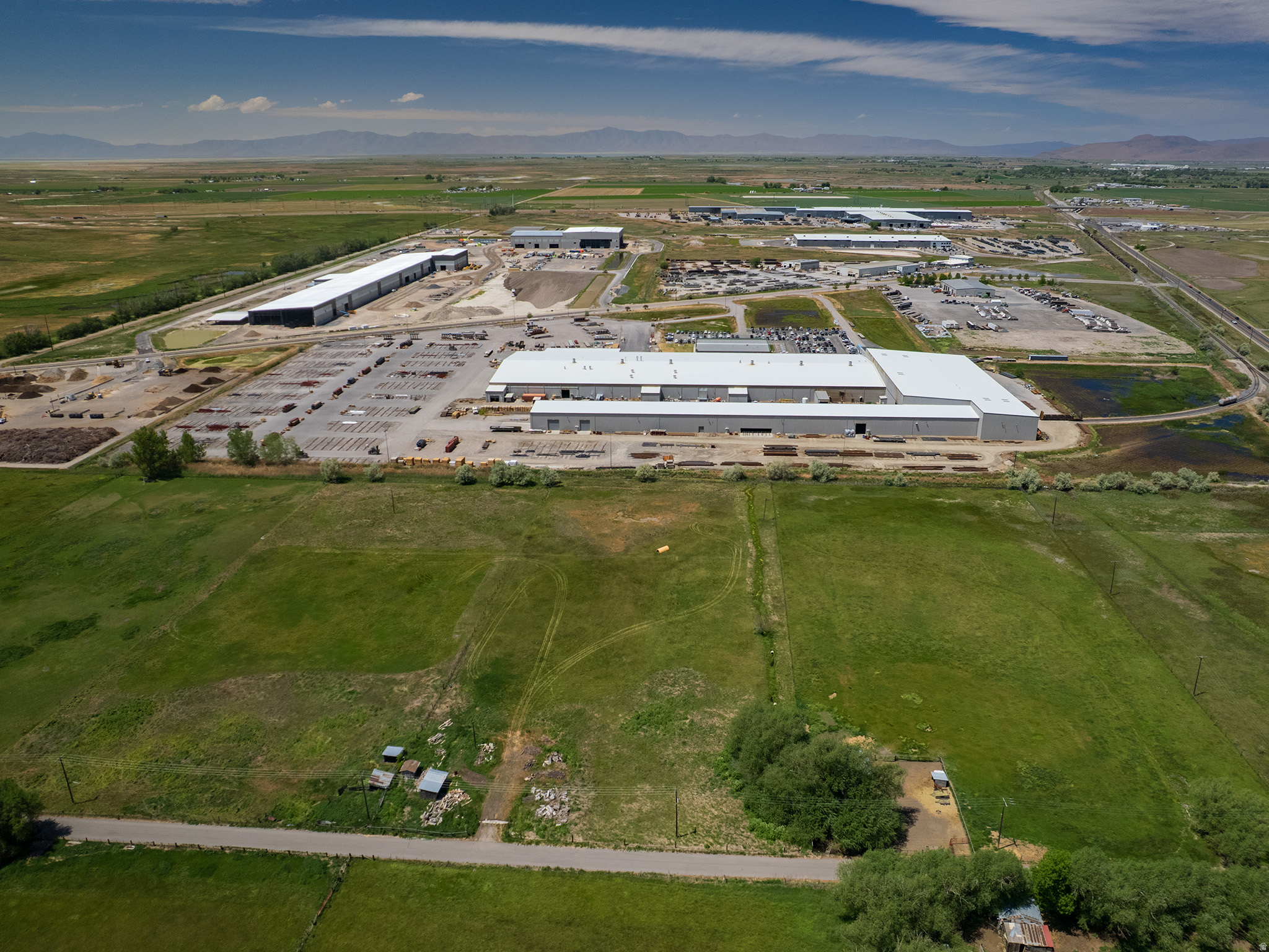 Prime industrial development opportunity featuring two contiguous parcels totaling 4.44 acres in Brigham City's growing industrial corridor. Located just south of Highway 13 and only two turns from Interstate 15 (**See Driving Direction**), this property offers exceptional access to Northern Utah's transportation and manufacturing network. Positioned near Nucor Corporation, the Brigham City Municipal Airport, and regional rail infrastructure, the site is well-suited for industrial, manufacturing, warehousing, distribution, contractor yard, and investment uses. The 2.07-acre Brigham City parcel is identified as Heavy Industrial within the City's General Plan, and city planning officials have outlined a potential pathway for annexation, parcel consolidation, rezoning, land-use approval, and future development of the adjoining county parcel. Flat, usable ground, strong transportation access, and proximity to major employers create a rare opportunity in one of Northern Utah's expanding industrial markets. With convenient access to Interstate 15, Highway 13, and key industrial employers, this property offers outstanding potential for future development and long-term investment. Buyer to verify all zoning, annexation, utility, and development requirements. Square footage figures are provided as a courtesy estimate only and were obtained from county records .  Buyer is advised to obtain an independent measurement.