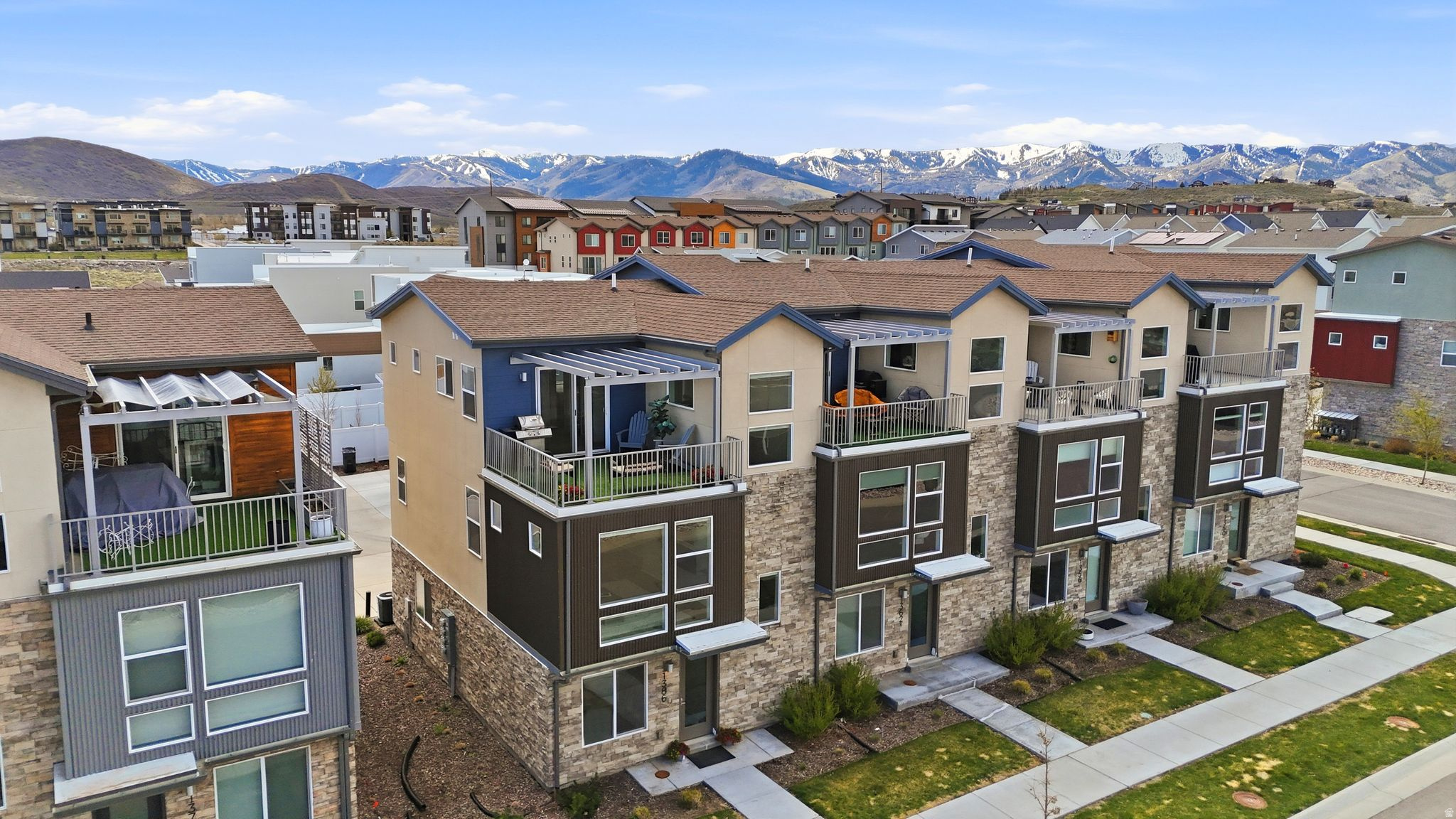 Rarely available end-unit townhome offering the privacy of a single-family home with only one shared wall and wraparound windows. This sun-drenched residence boasts $15,000 in recent upgrades, including brand-new luxury vinyl plank flooring throughout the first and second levels. This property is a gear-head's dream with a spacious two-car garage providing substantial storage for skis, bikes, and boards. The lifestyle continues on the private rooftop deck-a premier spot for sunset BBQs, a fire pit, or a hot tub.   The floor plan offers incredible versatility, featuring a lower-level 4th bedroom option perfect for guests or a home office. For the savvy buyer, this home is Short-Term Rental (STR) Eligible, offering incredible investment potential. Enjoy Energy Star efficiency with a tankless water heater and high-efficiency HVAC, all just 15 minutes from world-class skiing and 40 minutes from Salt Lake International. With community parks, splash pads, and a future "Main Street" retail hub, this is an investment in Park City's most exciting and affordable neighborhood. Own a piece of the future today!