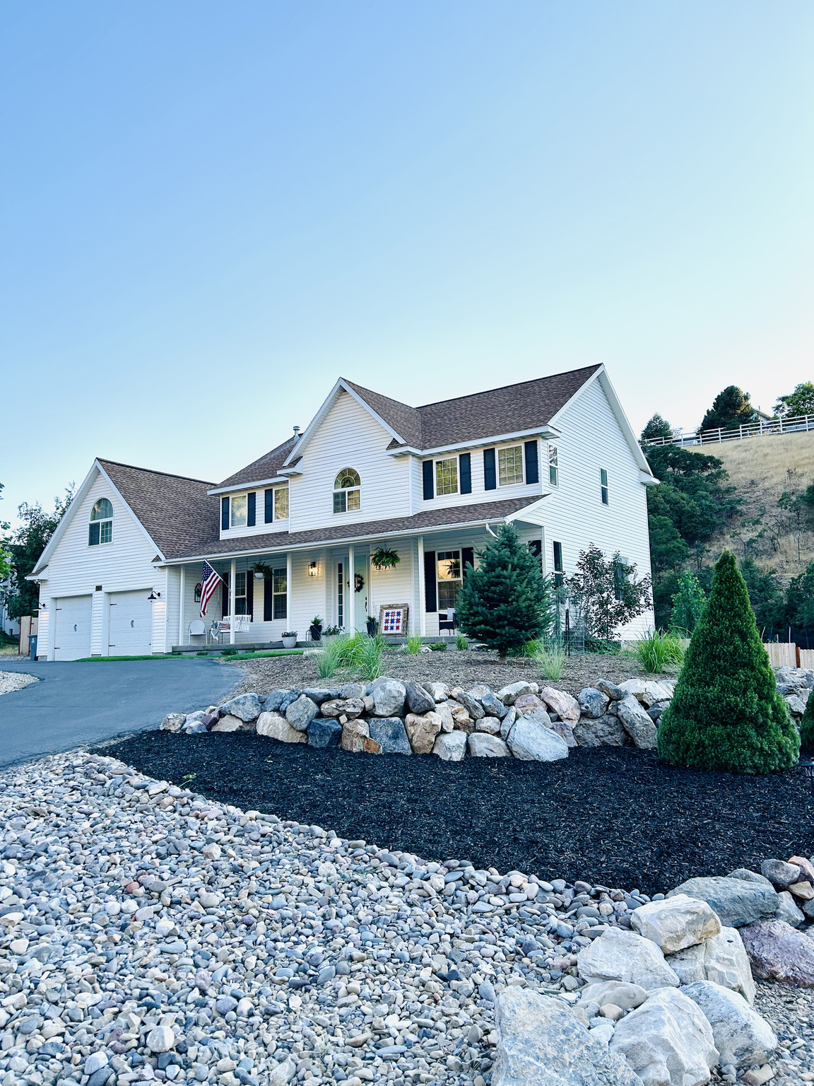 Traditional farmhouse style with the hard-to-find combination of privacy, square footage, potential multi-family living, and a large .925-acre lot. With a tree & brush covered hill behind you where you can watch wildlife (turkeys, deer and other animals) as well as wildlife across the road from the front of the house and up the hill, you will enjoy the unmatched privacy of living in Loafer Canyon. At nearly an acre, you can BRING YOUR HORSES TOO.  Home has a family room on each of the 3 levels, insuring plenty of room to gather and relax. A 2nd basement kitchen, basement laundry hook ups, and basement entrance offer a potential ADU (see Elk Ridge City for requirements). 5 bedrooms but potential for more. There is also an office (being used as a classroom) and a formal living room on the main floor. The upstairs family room (being used as a bedroom), has a built-in playhouse and a large built-in storage closet. Many storage closets throughout. Yoou'll be hard pressed to run out of hot water with double water heaters. Stay cozy in winter with a gas fireplace in the downstairs living room. 9 foot ceilings on the main level give it a spacious feel. The oversized garage with a pull-through shop area and rear garage door lead to a fully fenced backyard. There are raised bed gardens and a large in-ground garden. Automatic sprinklers make watering the apple trees, peach tree, strawberries, blackberries, raspberries and the rest of your garden easy. Relax on the rear deck or the pea gravel picnic area.  Hillside trails, a deep rustic sandbox, basketball standard, and a wood chip area for playground equipment add enjoyment for little ones. Plenty of parking for your family and guests. Newer large Lifetime storage shed included. Square footage is from county records. Spacious kitchen with pull out drawers in pantry area, two laundry rooms, huge master suite with huge master bather featuring double basin vanity, large shower, separate jetted tub and large walk-in closet. Walk-out basement. Dual heating systems and dual A/C units plus a water softening system. Great room is wired for surround sound and wired for outside speakers. You've got to see this one.