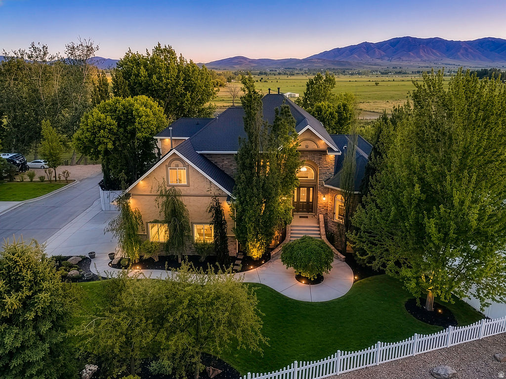 Discover this rare gem of property in Spring Lake Utah that sits on 4.86 acres of land nestled in a cul-de-sac with mountain views all around!! Enjoy a private pristine landscaped backyard with opportunity to own your own horse property with expansive room to run a personal business on open land with a detached 30x70 shop/barn. Just minutes from the freeway, 25 minutes to Orem, 15 min to Provo and Costco. Be sure to see 3D virtual tour. This remarkable well maintained property boasts an 7,757 square-foot custom-built home that has been fully renovated, new paint throughout, new carpet, freshly refinished wood floors, new appliances, and updated recessed lighting throughout. Step inside to find a two-story great room with 12 foot ceilings, 9 ft ceilings upstairs, a gourmet chef's kitchen, double ovens, cooktop, island seating, spacious main living primary bedroom with ensuite bathroom, and walk in closet.  Other notable amenities are 3 car garage with attic storage, 4.5 baths, 7 generously sized bedrooms, possible mother in law apartment with ADA accessibility, chair lift, wheelchair accessible bathroom, recreation room, custom vault safe, 3 laundry rooms on each floor, private basketball court/ pickle-ball court, fully fenced yard on all 4.86 acres backed to a running stream, playground, spacious garden, chicken coop, dog runs, horses corals, fruit trees, covered deck with breathtaking views, lantern lit stone patio outdoor fireplace with water fall features perfect for entertaining or enjoying Utah's stunning sunsets. The property's expansive grounds offer endless possibilities for expansion or customization. Buyer to verify all information in this report.