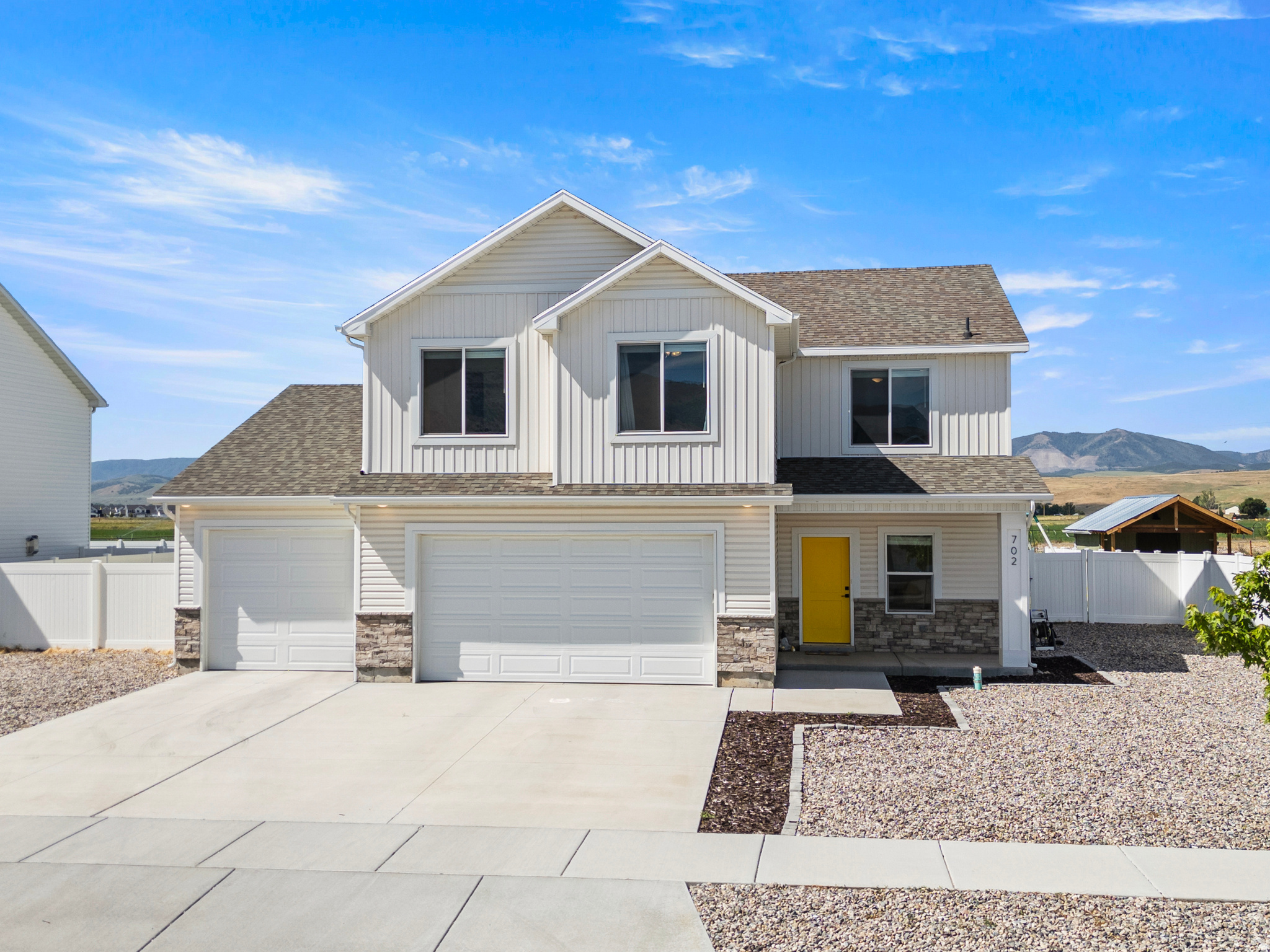 This thoughtfully designed floor plans provides comfortable living for everyday life and entertaining. One of the properties standout features is its premium back yard setting, backing directly to Hyrum City's irrigation retention pond.  Enjoy peaceful evenings and added privacy and the rare benefit of having no backyard neighbors. The home also features a spacious three car garage with an extended 3rd car bay, providing ample room for vehicles, recreational equipment, a workshop, or extra storage. Additional upgrades include a water softener, separate tub and shower in the primary suite. With its near new construction, scenic setting, generous lot, and exceptional privacy, this home offers a wonderful opportunity to enjoy living in beautiful Hyrum!