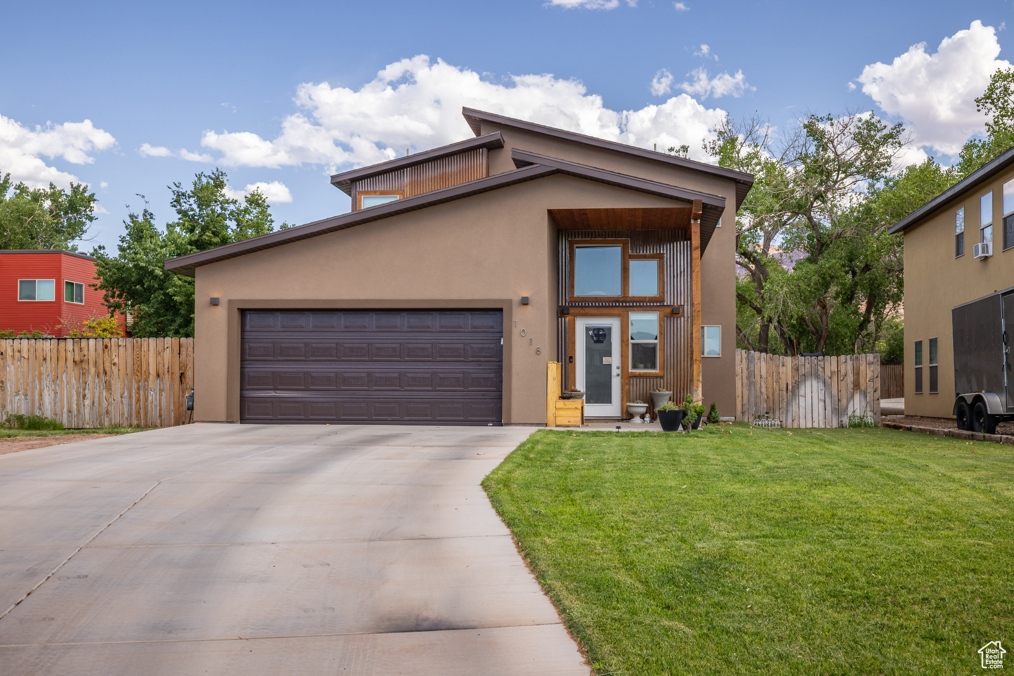 VALLEY VIEWS - A 5-bedroom, 2.5-bathroom sanctuary with superior trail access-welcome to your private gateway to Moab's wild beauty. The 950 square foot main floor of the home celebrates an effortless blend of modern comforts and natural elements. The kitchen, complete with rich wood cabinets, stainless steel appliances and concrete flooring, anchors the main living area, an inviting space perfect for hosting or settling in with loved ones for the evening. The main floor is also home to the spacious primary bedroom, featuring a walk-in closet and an en suite that grants a luxurious double vanity and an artfully tiled shower that feels like a retreat after a long day of adventure. Up the stairs, another 4 bedrooms and a full bath complete the 950 square foot second story. As you step outside to the backyard, you are greeted with a pristine and lush fenced-in yard and a side garden that promises seasons of fresh, homegrown produce, flowers or native vegetation-a perfect 0.16 acres for those with a green thumb. With unbeatable access to Mill Creek Canyon, hiking trails and swimming holes, this is your home  you can hit the trails with ease and take in everything Moab has to offer with the convenience of access to downtown near the Mill Creek Parkway!