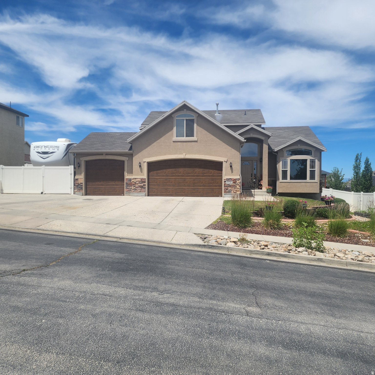 This stunning West Jordan two-story home masterfully combines spacious design with premium finishes, starting with a bright, semi-open floor plan accentuated by vaulted ceilings, a formal front living room, and a cozy family room centered around a warm gas fireplace. The heart of the home features a beautiful kitchen equipped with granite countertops, a central island, stainless-steel appliances, and a lovely dining area, while a rare main-floor bedroom and full bathroom offer ideal accommodations for guests. Upstairs, the luxurious primary suite serves as a private retreat with a walk-in closet and a garden tub, accompanied by two additional bedrooms, another full bath, and a large, versatile bonus room perfect for an office or reading nook. The fully finished basement adds massive value with an expansive recreation room, a full bath, and abundant storage space, making it perfect for hosting gatherings. Step outside into a fully fenced, beautifully landscaped backyard oasis complete with a covered deck for outdoor entertaining and a garden filled with herbs and berries. Complete with a three-car garage and a long RV pad for extra parking, this exceptional property is ready for you to call home. Buyer and buyer's agent to verify all information, including square footage; details are provided as a courtesy only.