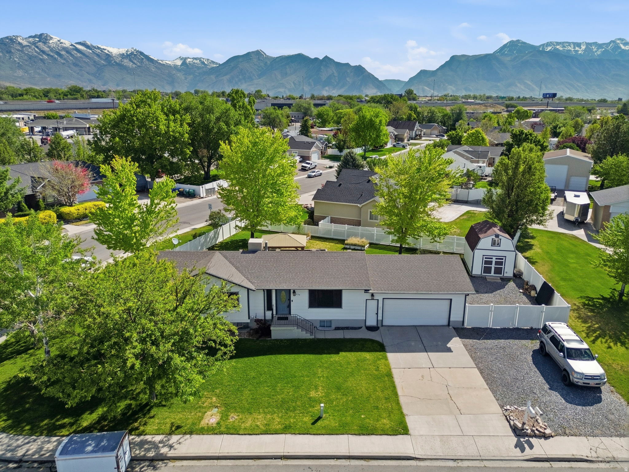 You asked for a Rambler home on a terrific lot with a HUGE RV parking area, close to the freeway in a great neighborhood... Here it is!  Welcome home to this Lehi rambler on a spacious corner lot with room to live, gather, store, park, and enjoy. The main level offers a comfortable, functional layout with 2 bedrooms and 2 bathrooms, including an updated kitchen that feels fresh, inviting, and ready for everyday living or entertaining.  The finished basement adds even more flexibility with 2 bedrooms, 1 bathroom a large family room, basement dry bar, second laundry room, and a huge storage room that is hard to find and easy to appreciate. Whether you need space for movie nights, guests, hobbies, food storage, holiday decor, or a home gym setup, this home gives you options. Outside, the fully fenced backyard offers a large yard with plenty of room to play, garden, entertain, or relax. The extra wide and extra long RV parking is a major bonus, along with a huge shed with power for tools, toys, equipment, or additional storage. With radiant heat, a desirable rambler layout, and a convenient Lehi location, this home offers the space and practicality buyers are looking for.