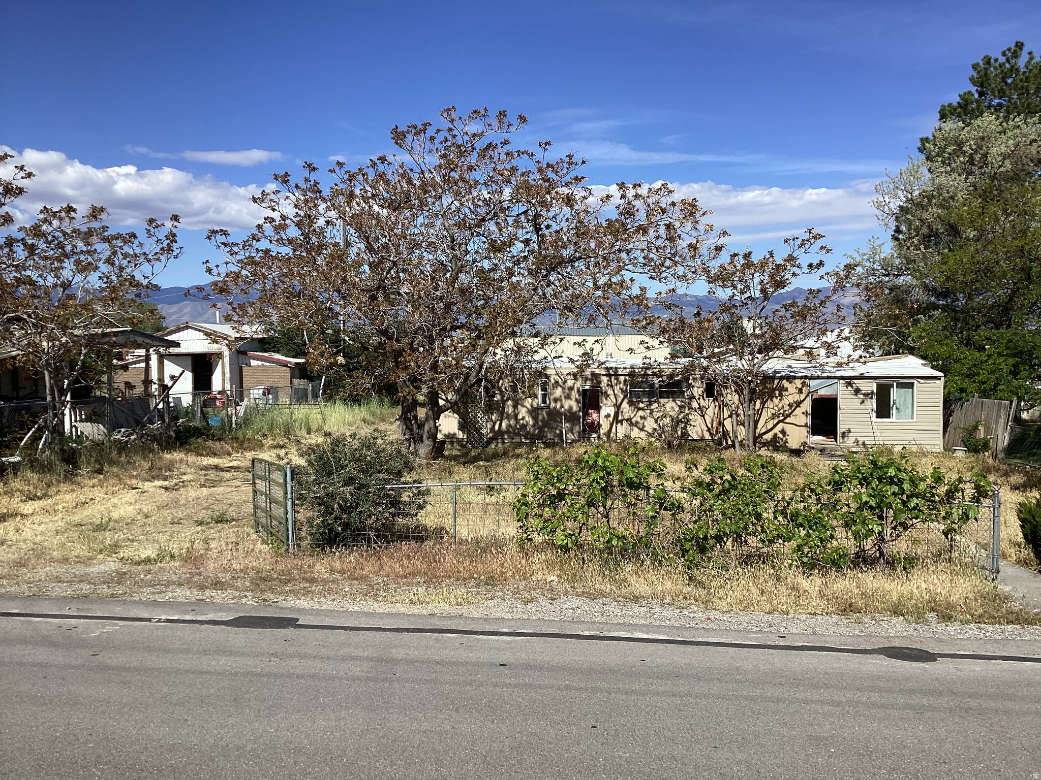Rare half acre HORSE PROPERTY on the West side of Tooele. It currently has a manufactured home on the property, which will be removed. All utilities are already there, and ready for you to build your dream home. This is a quiet, peaceful neighborhood, with friendly neighbors. LDS church 300 feet to the North, and a beautiful view of the Deseret Peek Temple a couple miles away. Zoning is RR-1. Agent/Owner.