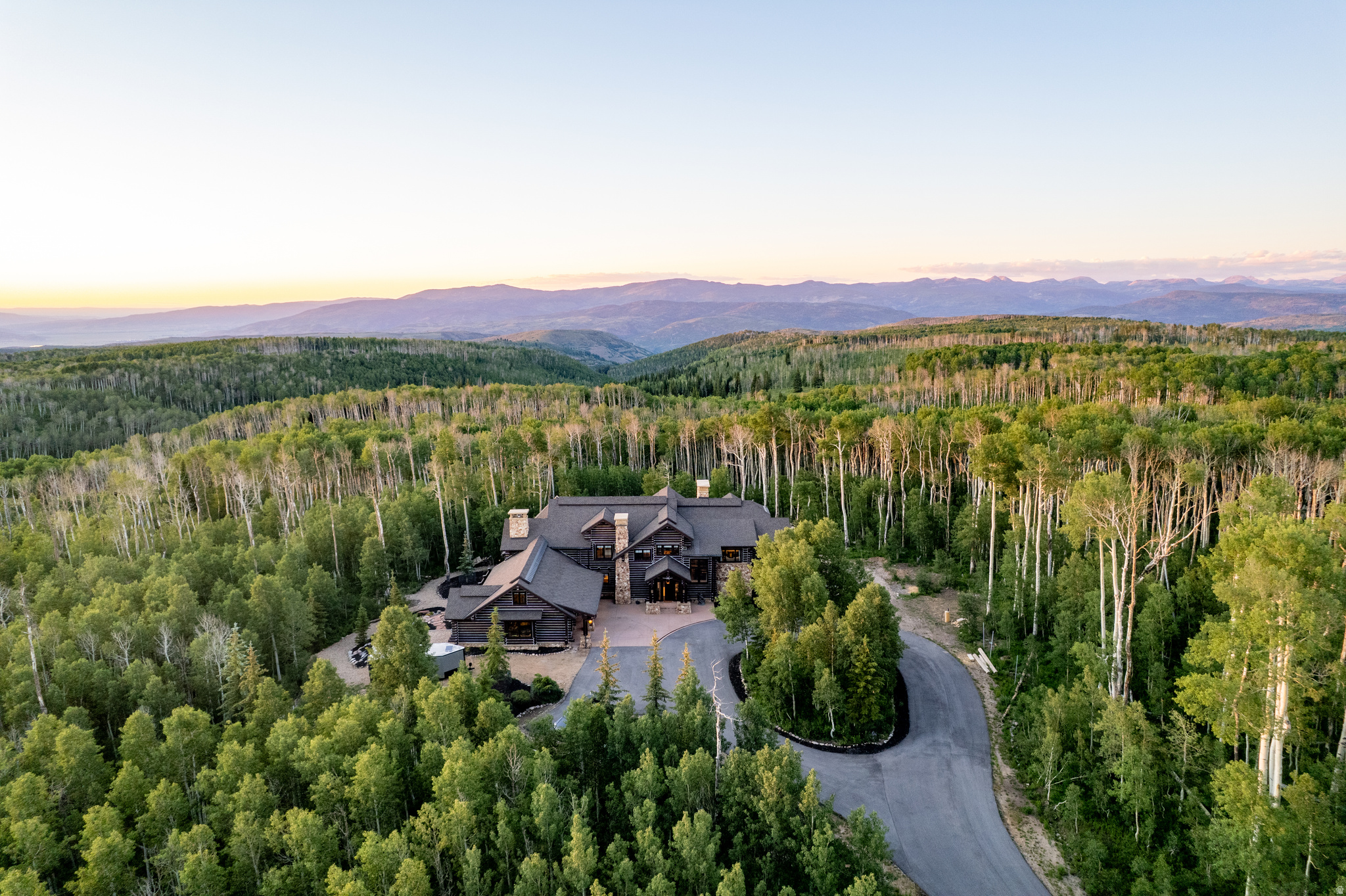 The Highlands is one of Wolf Creek Ranch's most extraordinary legacy estates, set on 160 private acres backing directly to the Uinta National Forest. Following a full, no-expense-spared remodel completed in 2025, this iconic mountain retreat offers the rare opportunity to own a truly move-in-ready luxury estate where timeless architecture, exceptional craftsmanship, and modern sophistication exist in perfect harmony.  Inspired by the grand lodges of America's National Parks and designed by JSA Architecture, the nearly 12,000-square-foot residence features soaring timber-framed ceilings, monumental stone fireplaces, hand-selected natural materials, and expansive walls of glass framing breathtaking mountain, meadow, and forest views. Every detail has been thoughtfully curated, creating a home that feels as refined as it is welcoming.  Designed for generations of family and friends to gather, the estate features seven private bedroom suites, a chef's kitchen with Wolf and Sub-Zero appliances, expansive entertaining spaces, custom theater with Kaleidescape system, game room, second full kitchen, sauna, hot tub, and oversized four-car garage. Wraparound decks invite seamless indoor-outdoor living, while a private lake and waterfront yurt offer unforgettable moments spent fishing, kayaking, or simply enjoying the surrounding beauty.  With 60+ miles of private trails, direct access to the Uinta National Forest, abundant wildlife, and endless opportunities for horseback riding, hiking, snowmobiling, and ATV adventures, The Highlands delivers an unparalleled four-season mountain lifestyle just minutes from Park City, Deer Valley Resort, and Heber Valley Airport.  A home of this caliber is not simply owned, it is stewarded, shared, and passed from one generation to the next.