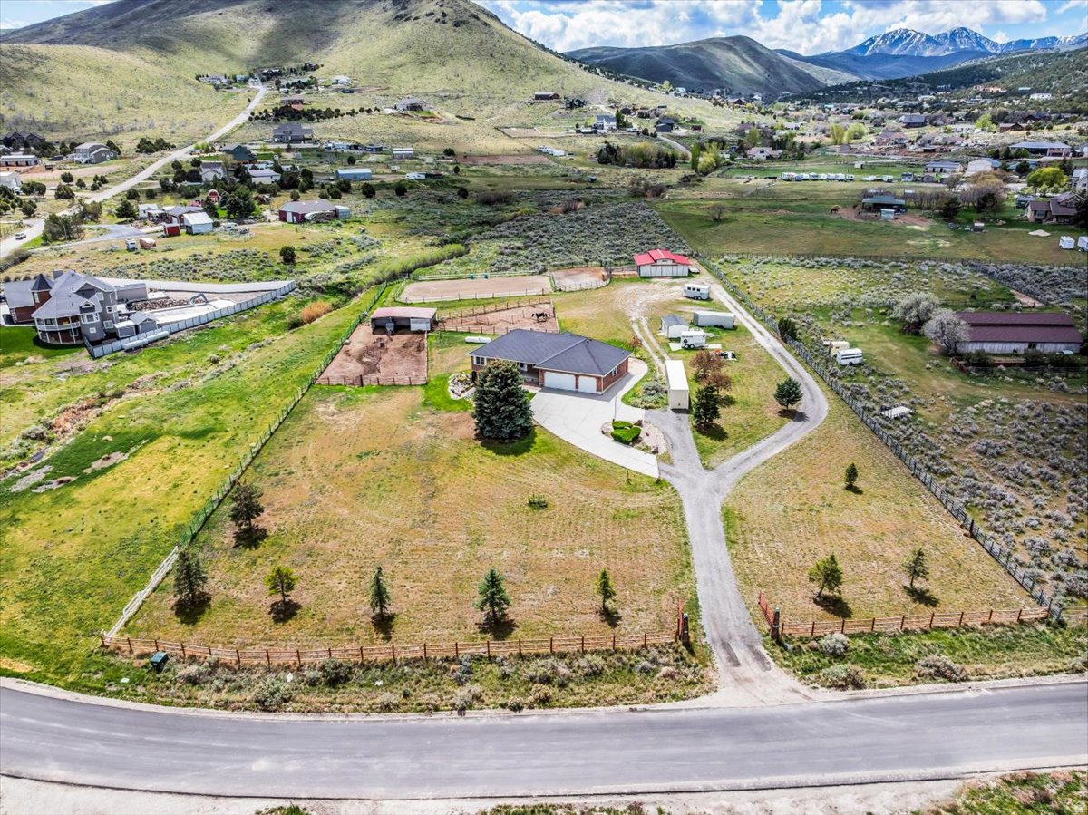 Improved Price! Enjoy the kind of lifestyle that gives you space to breathe, roam, and explore--set on 2.8 acres in desirable Hi Country Estates near Rose Canyon, just minutes from Yellow Fork Canyon's scenic trail system for hiking, horseback riding, biking, and snowshoeing. This fully fenced horse property is thoughtfully set up for both everyday living and long-term flexibility. The fully-finished, walk-out basement with updated lighting and finishes offers excellent potential for a future ADU-ideal for multi-generational living or added income...or leave as is and it's perfect for entertaining! Equestrian amenities are already in place with two barns and a shed. The 36x36 barn includes an arena, three stalls, tack room, and generous hay storage, while the 36x24 barn adds four more stalls and additional storage. Each stall is equipped with its own water source, making care simple and efficient. Recent updates provide peace of mind, including a newer furnace and AC (2021), paid-off solar, and 30-year shingles installed in 2017. The home also features a whole house humidifier, water softener (2026), new garage door opener, and an included garage air compressor with built-in hose access-perfect for tools, toys, and keeping everything ready to go. Whether you're bringing horses, hobbies, or simply craving open space and connection to the outdoors, this property offers a rare opportunity to create the lifestyle you've been looking for.