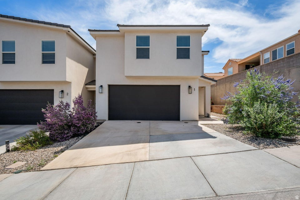 Welcome to Spanish Townhomes where you will find this beautifully appointed 3-bedroom, 2.5-bath home. Offering a fresh modern aesthetic with thoughtful upgrades throughout. The open concept main level features luxury vinyl plank flooring, recessed lighting, and a show-stopping kitchen with white shaker cabinets, sage green island, quartz countertops, stainless steel appliances and a gas range. The primary en-suite is composed of a stunning double vanity, sleek black fixtures, gold cage lighting, and a frameless glass walk-in shower. Two additional bedrooms provide generous space and natural light throughout. Half bath on the main level is ideal for guests. Two car garage, low maintenance yard, and a fantastic location make this one you don't want to miss. Near the private park, Legacy Park and just minutes from Zion National Park, Hurricane, and St. George!