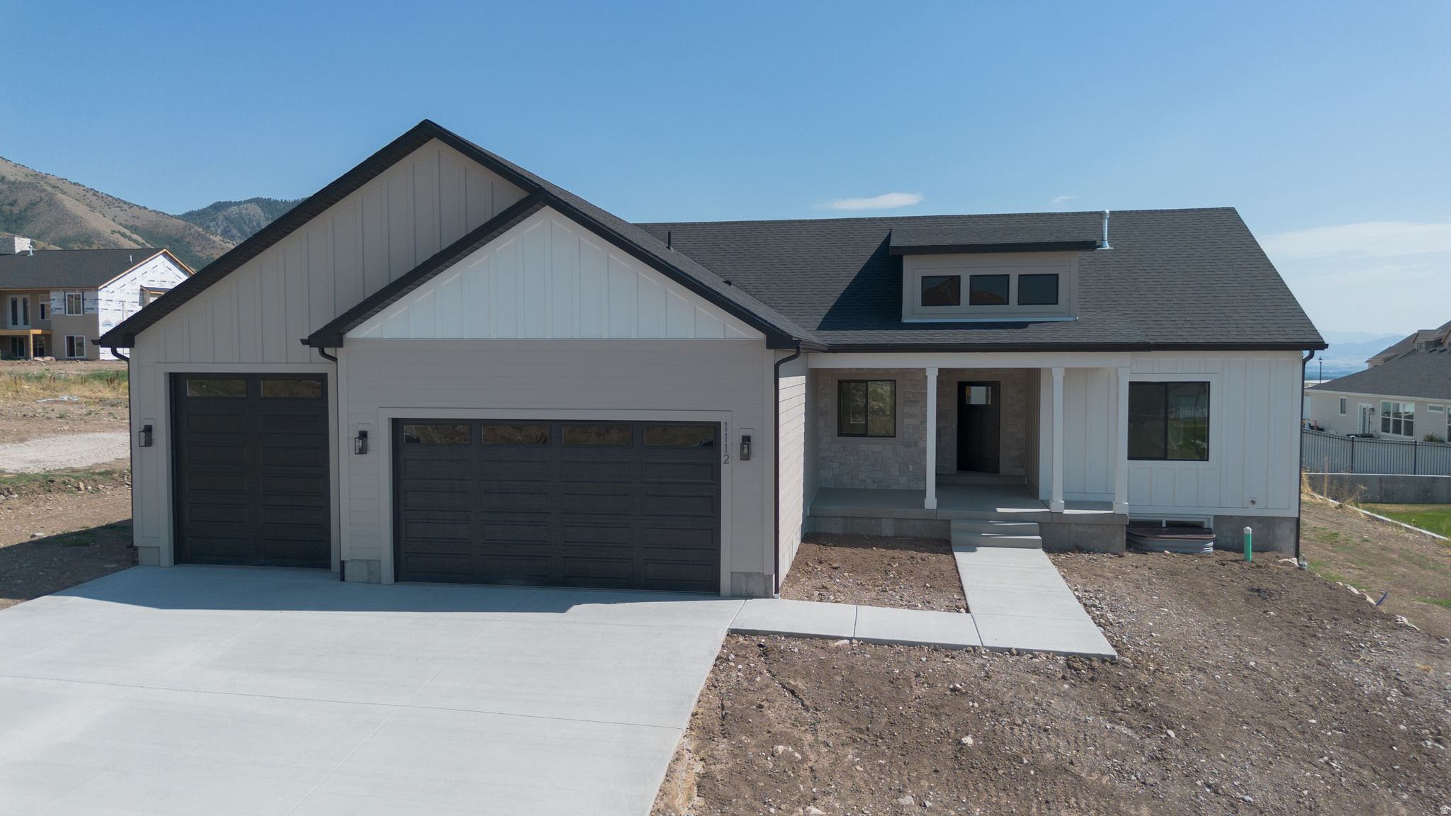Welcome to an exceptional new home on Hyde Parks east bench. This beautifully designed 4,073 sq ft, 6 bedroom, 3 1/2 bathroom home offers the perfect blend of luxury, functionality, and timeless style. Built by an experienced custom builder known for superior craftsmanship, this home is thoughtfully designed from start to finish using top-tier subcontractors and high-quality materials throughout. Step inside and discover a bright, open-concept layout featuring 9' ceilings & luxury vinyl flooring across the entire main level. Insulated 3-Car Garage. Other upgrades include a 28x10 covered patio, gas fireplace with rock, mantel with built in lower cabinets and floating shelves. Custom mud bench with hooks. 100% finished basement with lower cabinets for kitchenette. Custom woodwork including shiplap, black Low E windows, quartz countertops, delta touch faucet in kitchen, cultured marble shower and tub surround. Painted and stained cabinets with soft close drawers. Framed mirrors, euro glass shower door, closet organizers, roll outs on all lower cabinets. Builder is willing to do a bid on adding a basement entrance/walkout.