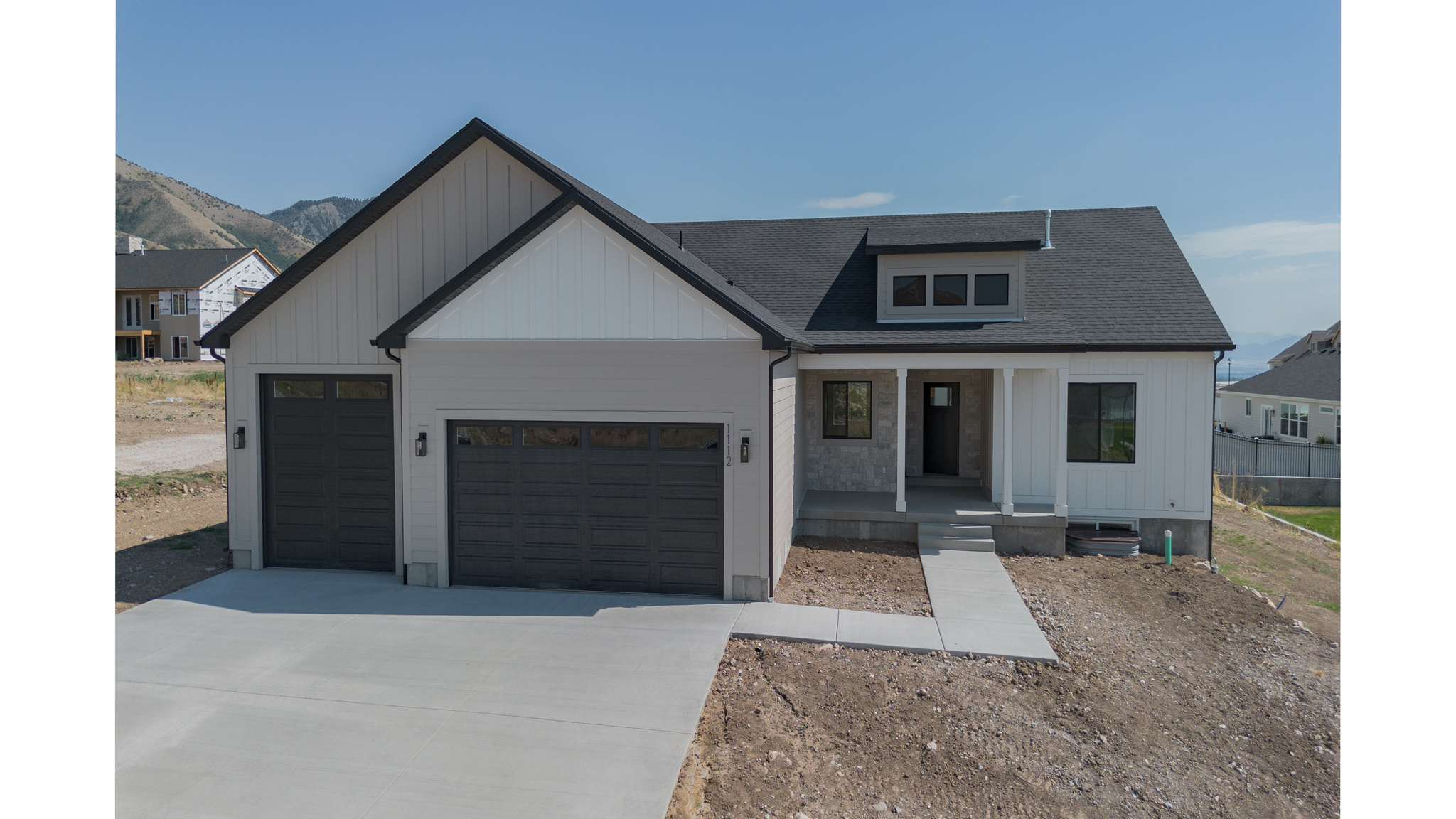 Welcome to an exceptional new home on Hyde Parks east bench. This beautifully designed 4,073 sq ft, 6 bedroom, 3 1/2 bathroom home offers the perfect blend of luxury, functionality, and timeless style. Built by an experienced custom builder known for superior craftsmanship, this home is thoughtfully designed from start to finish using top-tier subcontractors and high-quality materials throughout. Step inside and discover a bright, open-concept layout featuring 9' ceilings & luxury vinyl flooring across the entire main level. Insulated 3-Car Garage. Other upgrades include a 28x10 covered patio, gas fireplace with rock, mantel with built in lower cabinets and floating shelves. Custom mud bench with hooks. 100% finished basement with lower cabinets for kitchenette. Custom woodwork including shiplap, black Low E windows, quartz countertops, delta touch faucet in kitchen, cultured marble shower and tub surround. Painted and stained cabinets with soft close drawers. Framed mirrors, euro glass shower door, closet organizers, roll outs on all lower cabinets. Builder is willing to do a bid on adding a basement entrance/walkout.