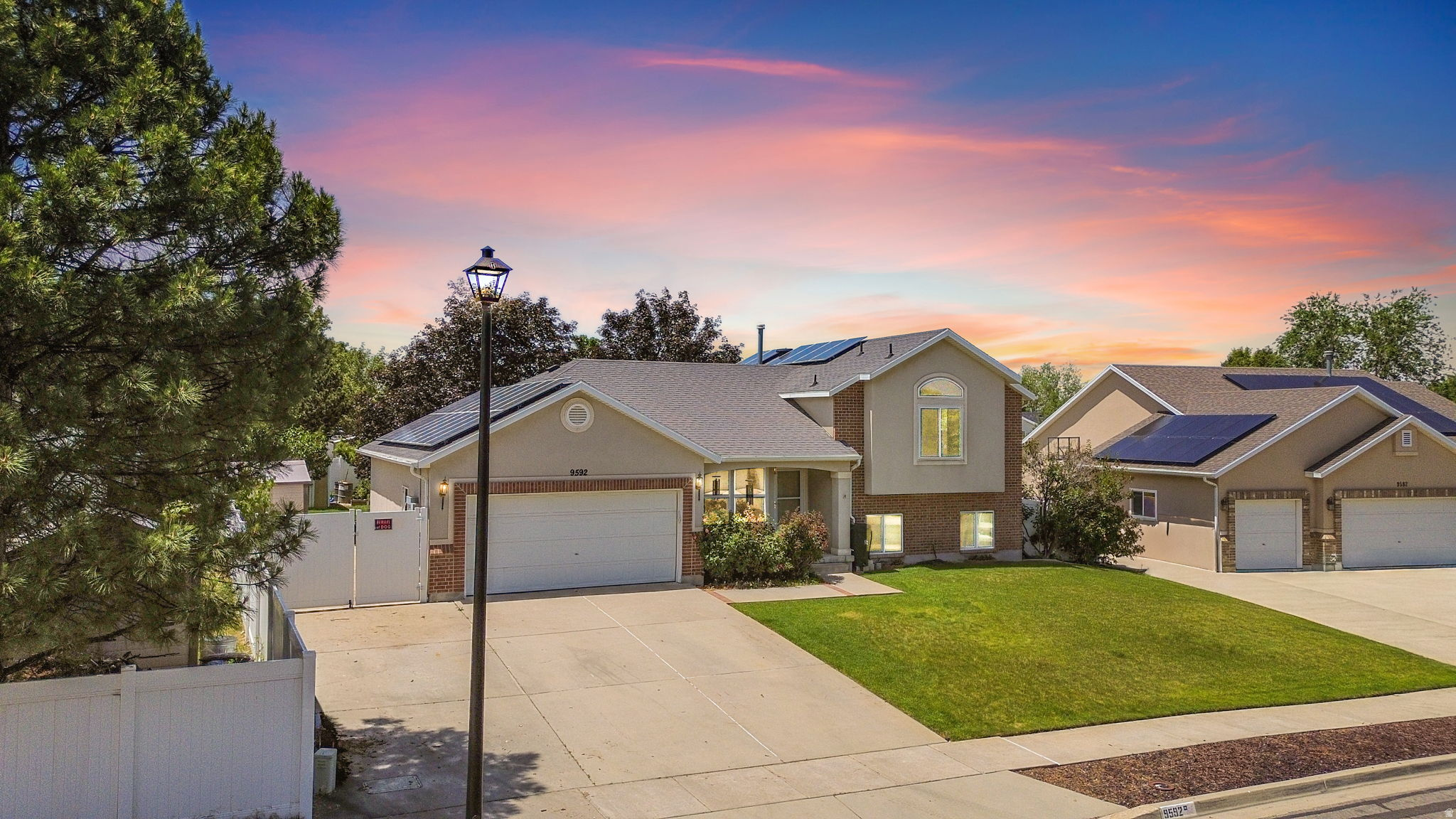 This is it! Fantastic neighborhood (and really great neighbors). Only a few yards from neighborhood Skye Park, and about 1 mile from the new Bingham Regional Park. Less than a mile from the Glenmore Golf Course. Short walking distance from Trax Red Line. Enjoy sunsets or friends/family BBQs from large backyard covered patio. Many upgrades: Triple pane windows, extra attic insulation. Tesla battery and solar panels give you 24/7 confidence you'll always have power, and save about $1500-$2,000 per year on your electric bill. Vaulted ceilings in the living room and primary bedroom. Large storage shed in back yard, and tons of quality storage shelves in the 3 car garage. More storage (entire room w/built in shelves) in the basement, along with yet ANOTHER room as a partially finished 5th bedroom. RV or "toy" parking behind fence on the side. Mature shade trees in back yard. Garden grow boxes.   Square footage figures are provided as a courtesy estimate only. Buyer is advised to obtain an independent measurement.