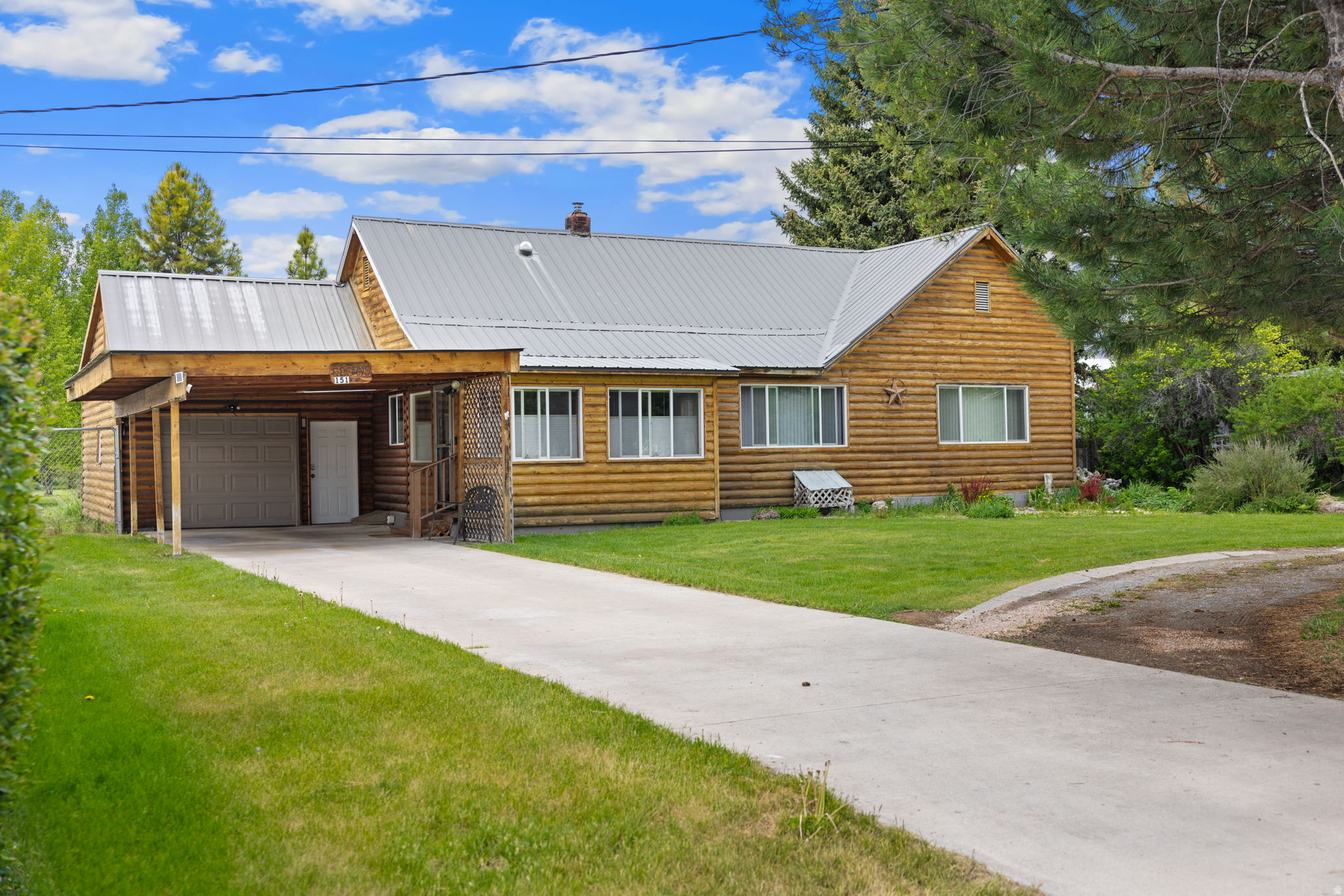 One of a kind Montpelier home with log siding, a sunroom entrance, a separate dining area with a freestanding gas fireplace, and a living room. Upstairs has a bedroom, while the lower level includes a family room, storage, and a jetted tub. Outside, the property offers an attached garage, extra covered parking, and a half-circle driveway. Mature trees frame a surprisingly large backyard for an in-town lot, complete with a greenhouse and fruit trees including plum, chokecherry, and four varieties of apples. A 20x20 shop, two metal sheds, and a hay barn provide plenty of practical space. Everything you need is close by schools, parks, shopping, and even the golf course making this a rare combination of usable land and convenient location.  OPEN HOUSE 6/12/2026 4:00pm-7:00pm