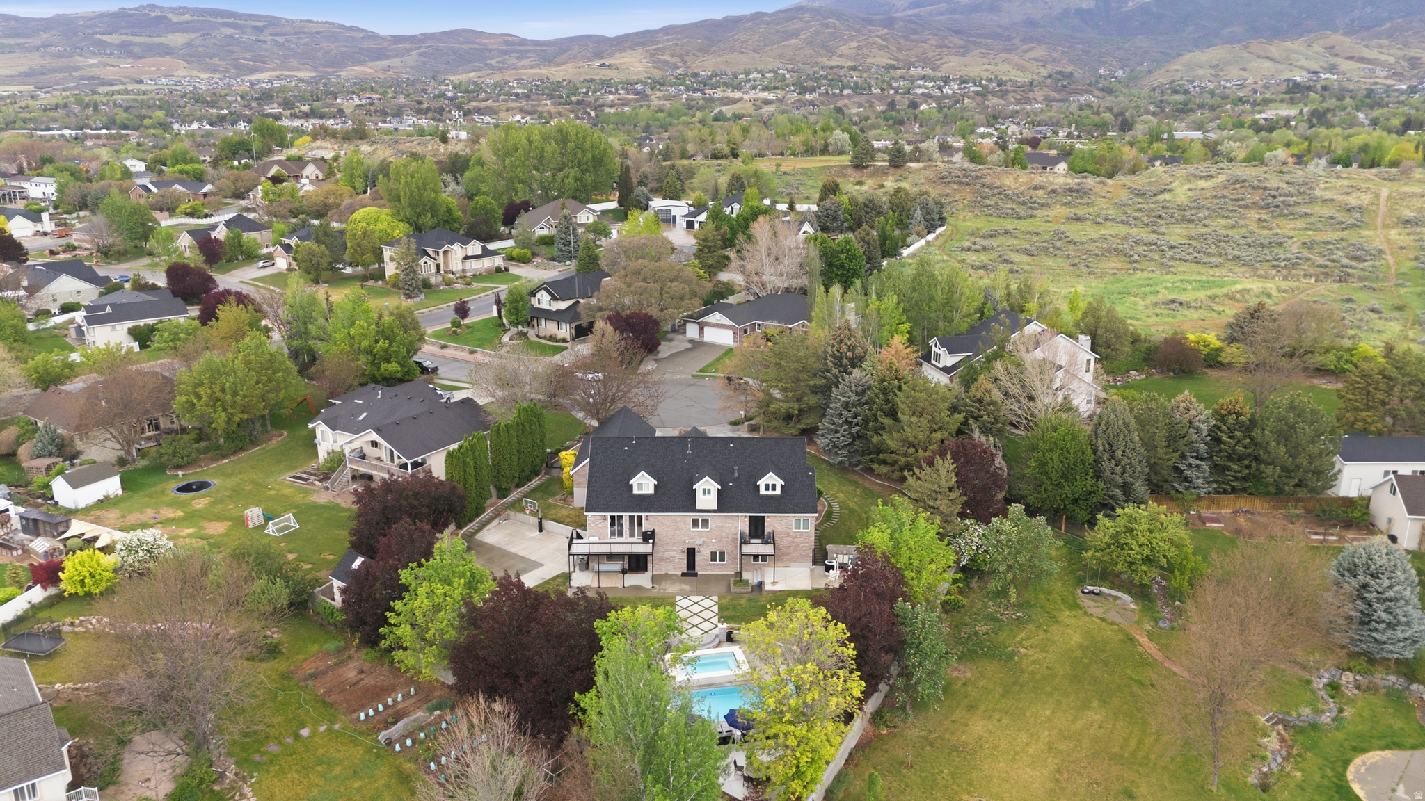 Completely remodeled in 2022, this exceptional Alpine estate sits on a quiet cul-de-sac and blends luxury with thoughtful design throughout. Highlights include beautiful new wood gridded and non-gridded Pella windows, European white oak floors, iron doors, and a Gourmet Chef's Kitchen with a 12x5 walnut island, quartzite surfaces, 48-inch 6-burner Thermador range with griddle stove, 36-inch SubZero fridge, 36-inch SubZero freezer, 2 Bosch dishwashers, 2 warming drawers, and 2 butler's pantries. The lower level features a mother-in-law apartment with private entrance, full kitchen, laundry, bath, and 2 bedrooms. Resort-style backyard offers 2 fiberglass saltwater pools, the second pool  seats 20+, heats above 100 degrees for a hot tub, or chills to approximately 42 degrees for cold plunges. Plus a regulation-size pickleball court/basketball court and mature landscaping. New roof in 2020. Minutes from American Fork Canyon, Alpine Country Club, Cedar Hills Golf Club, multiple parks, and Thanksgiving Point for shopping, dining, and entertainment.