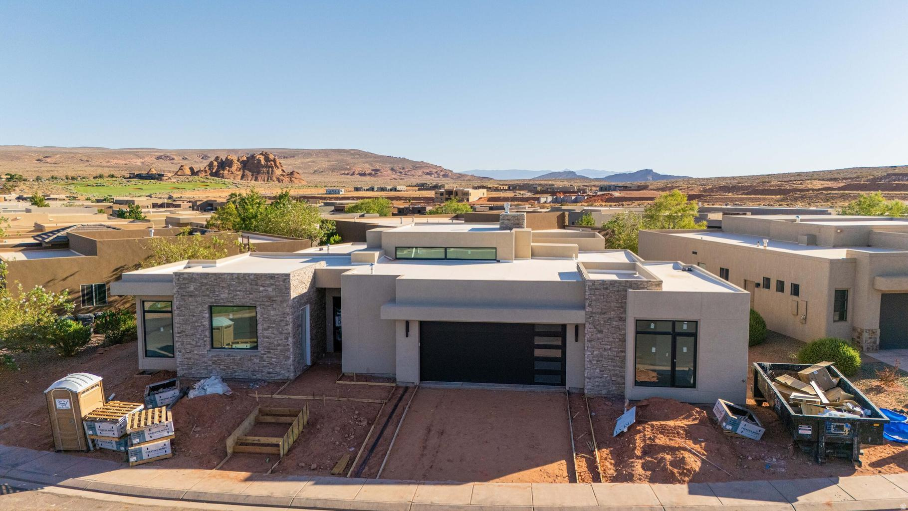 Estimated Completion: August 2026. This stunning 4-bedroom home in The Dunes at Sand Hollow, features a modern exterior, open-concept living spaces filled with natural light with the many windows, and indoor-outdoor flow to a private backyard with a pool. The spacious primary suite offers a tub and walk-in shower and three additional bedrooms that provide flexibility for family or guests. One of those bedrooms is an attached apartment with its own private entrance and mini split that's perfect for visitors. Enjoy the added privacy, beautifully maintained surroundings, and elevated lifestyle that come with golf course living all in one of the area's most desirable communities.  Residents enjoy access to the exclusive Sand Hollow Clubhouse and championship golf course, with discounted golf privileges, along with The Grille restaurant, seasonal pools, a fitness center, and nearby shopping. The HOA covers landscaping, maintenance of common areas, and access to the community pool and gym, plus the added peace of mind of hourly security patrol throughout the neighborhood.
