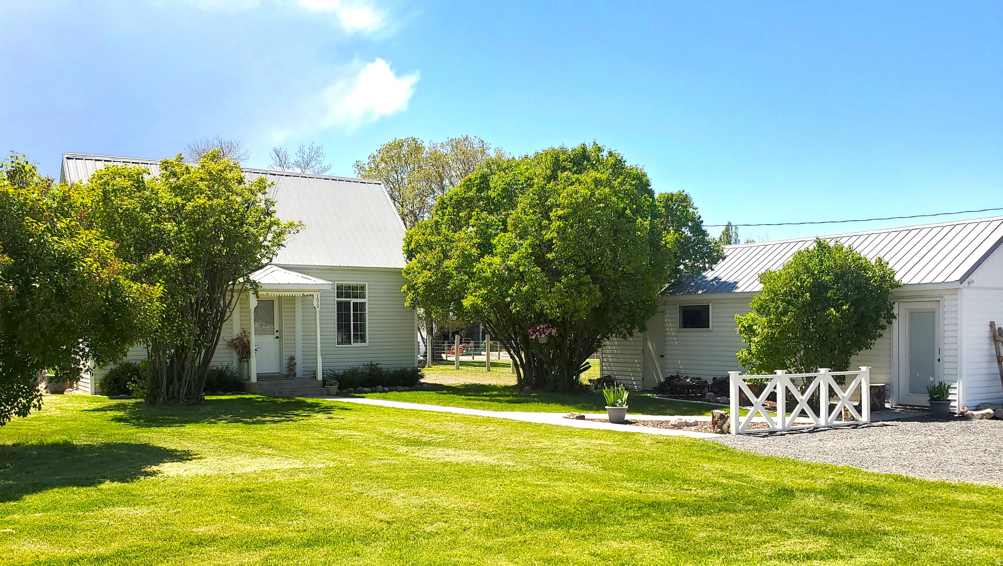 Charming country home in the Heart of Paradise on a corner lot and quiet street. 360 degree breathtaking views of majestic colorful mountains. PRIMARY RESIDENCE: Current owners have upgraded to make the 1901 farmhouse more beautiful while keeping its country charm. New paint and crown molding throughout. New LED lighting and fans installed. High (~10 ft.) ceiling kitchen has large insulated window shade, quartz countertops, and new tile flooring. An outer door added in SW bedroom as an entrance/exit for home on west side of house. MUDROOM: Screened entrance with storage by side porch on East side of house. CELLAR: Extra storage with built-in shelves, water heater, water softener, and furnace. ROOF and ATTIC: Updated galvanized steel roof for longevity combined with large attic space help provide good insulation. BONUS: Outdoor shed/shop near front of house (15' X 25" ft...or 375sf) has been converted for a place to relax or entertain. It has a wood stove for heating, picture windows, 2 doors, and vinyl flooring. The back room can easily be converted to a bathroom and still be in conformance with Paradise City codes. The bonus structure square footage is not included in the listed primary home square footage. SPACIOUS 2-CAR GARAGE: (30 x 36'...1,080 sf.) has windows, side door with porch cover, 2 very large storage closets with shelving and lights, additional built-in shelving, and modern cabinets in main garage area. City code allows for a breezeway to connect this garage to the primary home to more than double the living space if so desired (another garage, carport or even shop could be added in numerous locations on the flat property). LARGE CHICKEN COOP: Behind large garage. FIELD: Fully fenced for horses, cattle, or other animals or for recreation. Comes with 1.5 water shares. GARDEN AREA: The equivalent of 12 garden boxes with drip lines. Raspberries, strawberries, rhubarb, blackberry bush, peach tree, and perennial flowers. YARD: New automated sprinkler system installed in surrounding yard. This is a turnkey property as is and has great potential for expansion. See it to experience a little bit of "Paradise" in Paradise. Note that some photos are from different seasons to show the property in various settings, while most of the photos are current. Also, some furnishings may stay while others may need negotiation with a separate Bill of Sale (TBD). Showings will begin with an open house on Saturday, May 9th from 10:00 a.m. through 4:00 p.m. *Agent related to the Sellers