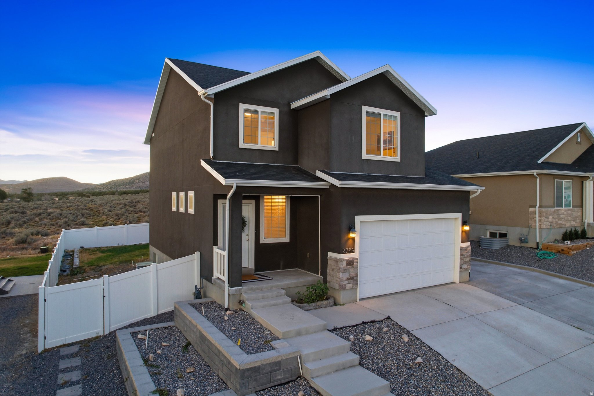 OPEN HOUSE Sat 7/18 11am-1pm. 2.99% assumable loan (ask for details). Nestled in Eagle Mountain's highly desirable Eagle Point community, this beautiful 5-bedroom, 3.5-bathroom modern farmhouse perfectly blends functional family living with breathtaking, unobstructed mountain views. Step from the welcoming front porch into a main floor designed for modern life. A spacious entry features a built-in mud bench and a convenient half bath before opening up into a spectacular open-concept living, dining, and kitchen area. Framed by sweeping mountain backdrops, this space is an entertainer's dream. The kitchen boasts a large island with granite countertops, a huge walk-in pantry, and seamless access to the large laundry room and a second mud bench leading to the 2-car garage. Double sliding glass doors lead out to a fully fenced backyard-a blank canvas for your dream outdoor oasis. Upstairs, a cozy central loft offers the perfect flexible space for a home office, playroom, or reading nook. The grand primary suite is a true sanctuary, complete with room for seating to maximize the mountain views. Double vanities, a separate soaking tub, an oversized shower, private water closet, and a generous walk-in closet complete the primary suite. Two additional large bedrooms feature built-in closet organizers and share a clever hall bath designed with a privacy door between the vanity and shower. The fully finished basement opens up a world of possibilities. Currently configured as a salon with a waiting area and a full bath, it is already fully wired and plumbed for a future kitchen (see AI generated picture for example). Whether you want to use it as a mother-in-law apartment for rental income, a dedicated home business, or an epic guest suite, the flexibility is unlimited! Enjoy all the perks of a vibrant neighborhood with no HOA dues. You're just minutes away from the massive Cory Wride Memorial Park, local shopping, and dining, with a charming neighborhood park right down the street. Complete with adjacent RV parking out front, this Eagle Mountain gem truly has it all! *Square footage figures are provided as a courtesy estimate only and were obtained from tax records.  Buyer is advised to obtain an independent measurement.