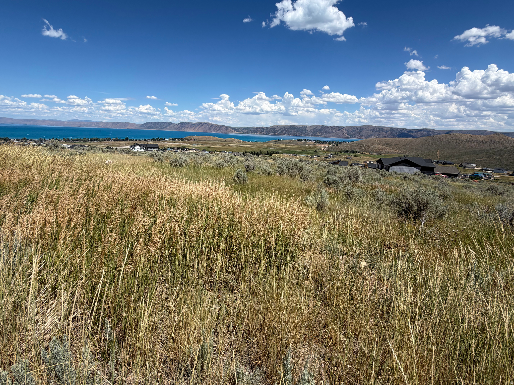 Build your dream home or vacation getaway on this beautiful mostly flat lot in Sweetwater Subdivision overlooking stunning Bear Lake! Enjoy views of the mountains and the Lake in this peaceful setting with plenty of room to create the perfect retreat. Access to Ideal Beach is optional featuring private sandy beaches, swimming pools, hot tubs, tennis and pickleball courts and other amenities. Don't miss out of this prime homesite with incredible views and outstanding recreation just minutes away!