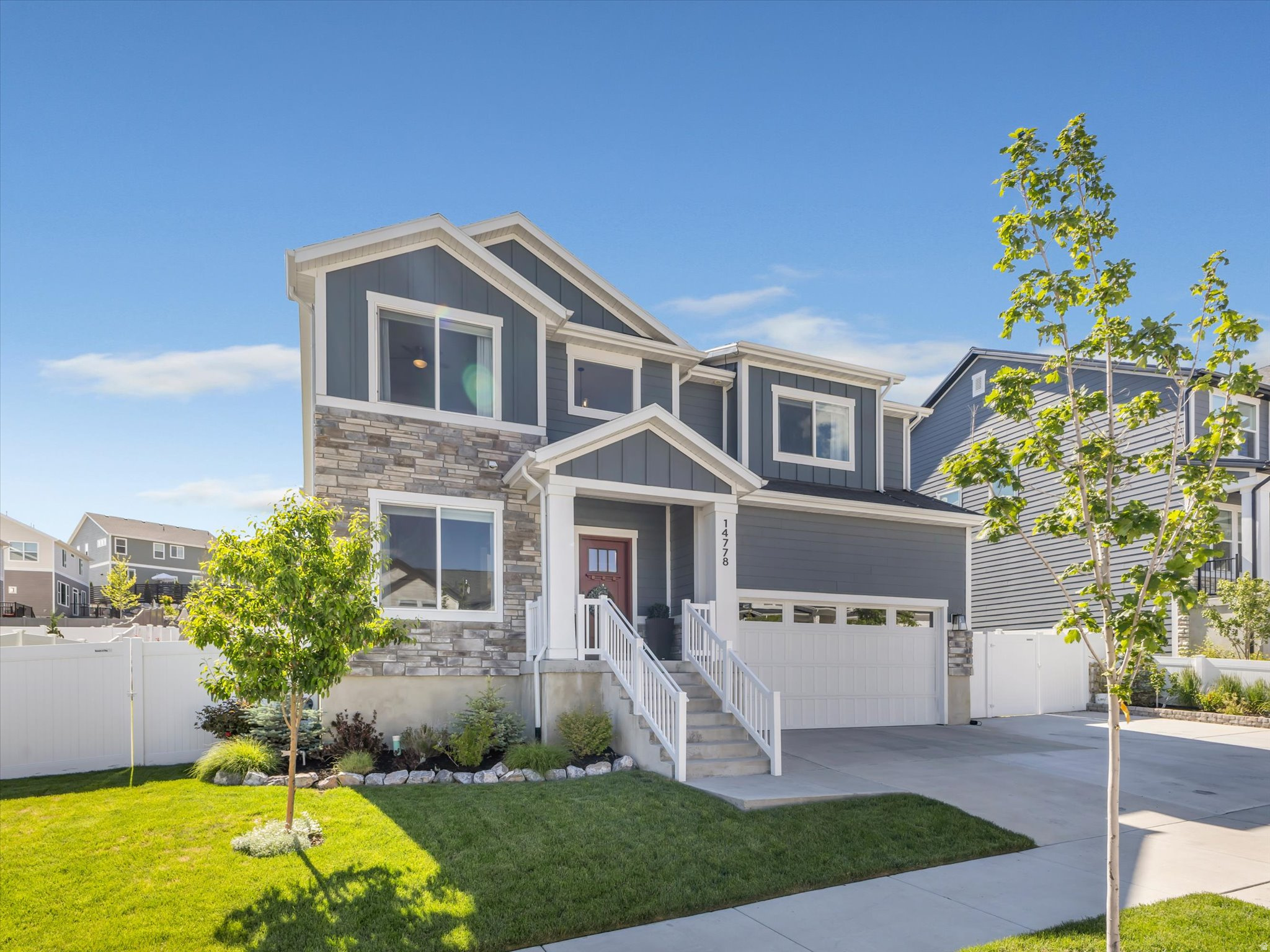 Most homes have a thing. A layout that almost works. A yard that needs more weekends than you have. A garage that fits two cars if you don't open the doors all the way. You know the thing.  Springtime Road doesn't have a thing.  From the moment you pull up, Lone Peak is right there out front, doing its thing. And that front lawn - you'll probably assume it's turf. It's that green. It's not. It's just that well-kept. Out back, turf keeps things tidy and green year-round without the water bill or the weekend obligation.  Step inside and the living room opens up to ceilings pushing past 20 feet, flooding the main floor with light and giving the whole space a scale you feel before you can name it. The kitchen and dining room flow naturally off it, the kind of setup where Saturday morning breakfast bleeds into a long conversation without anyone noticing. A dedicated office sits on the main floor for the days you need a door between you and everything else, though it flexes easily if your life calls for something different.  Upstairs, all four bedrooms share the same level. The primary suite has the space and separation you want, and the guest bathroom and laundry are right where they should be. No hauling baskets up and down stairs, no hunting for a linen closet three rooms away. Everything landed on the right floor.  Oversized garage with extra parking on the side, and no HOA means the boat, the camper, the trailer is welcome here.  And here's the detail the listing photos won't tell you: Peak View Trailhead is minutes away, and the Two Hollows Trail is one of those local favorites that somehow stays off the radar. Regulars know it. You'll know it. The kind of trail you feel a little smug about on the way back to your car.  Most homes have a thing. This one just makes sense.