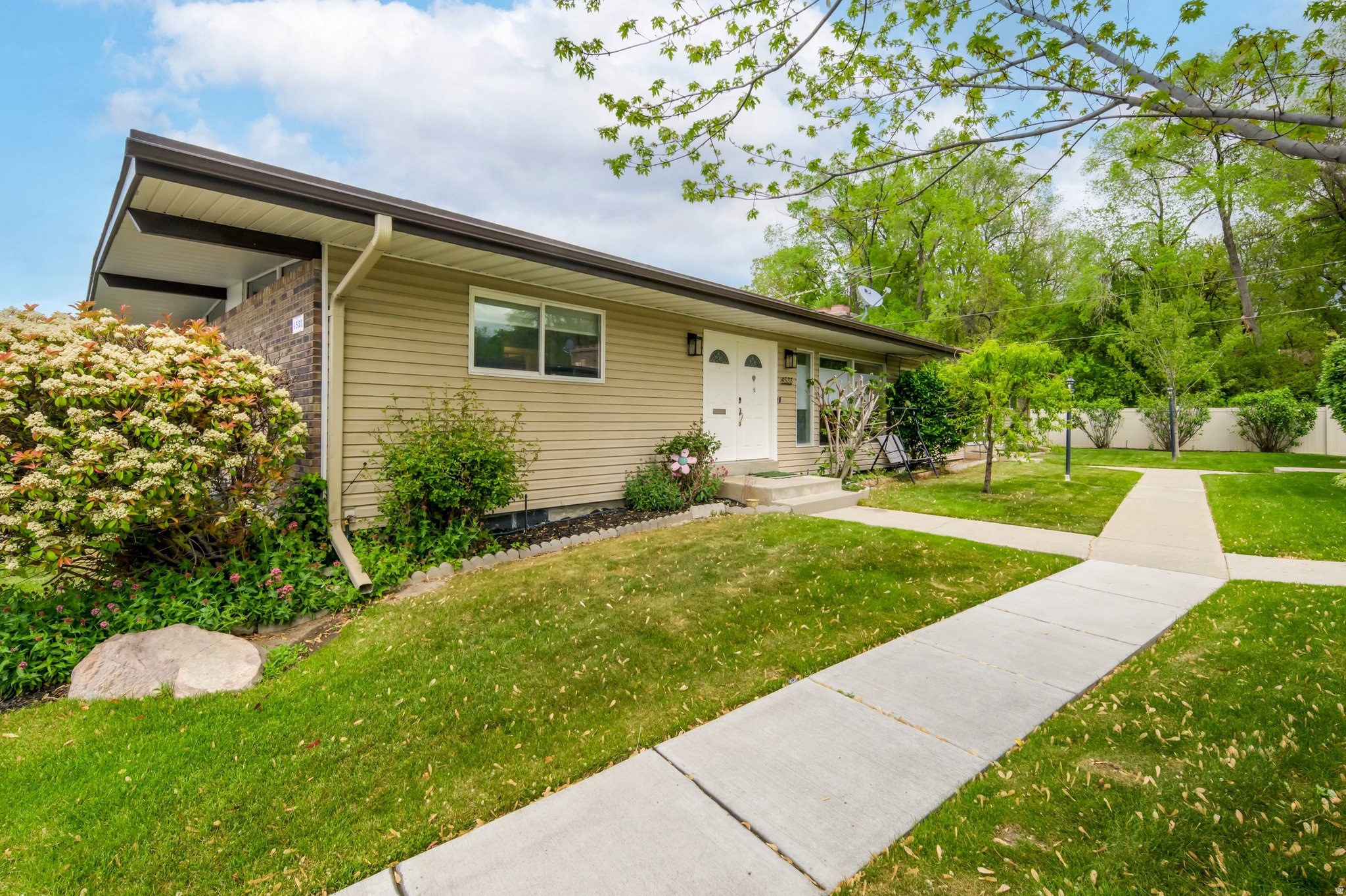 Tucked into a quiet, rarely available community in desirable Holladay, this rambler-style condominium offers easy, single-level living with the added flexibility of a fully finished basement. The main floor features two bedrooms and two bathrooms, including a primary suite with a private three-quarter en-suite bathroom. Hardwood flooring runs throughout both levels, creating a clean, cohesive feel. Downstairs, you'll find two additional bedrooms, a full bathroom, and plenty of space for guests, a home office, or hobbies. Enjoy outdoor living on the covered patio perfect for relaxing or entertaining. The attached two car carport offers convenience today with the potential to be enclosed and converted into a garage. A rare opportunity in a sought after location with low turnover, don't miss it. Reverse osmosis system has been added. Updated basement windows, new furnace/AC 2025, new refrigerator 2025, new microwave 2026. Square footage figures are provided as a courtesy estimate only and were obtained from county records. Buyer is advised to obtain an independent measurement. Buyer/Buyer's Agent to verify all info.