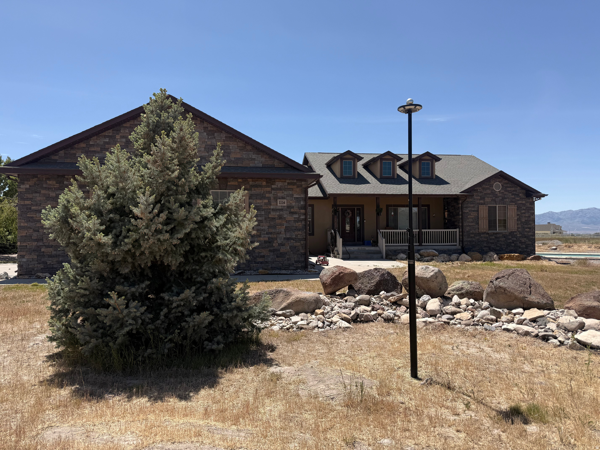 Country living, mountain views, and endless possibilities-all on nearly 6 acres. This incredible property offers the kind of space, functionality, and lifestyle that's hard to find. The home features 5 bedrooms, spacious living areas, and the opportunity to add your own personal touches while gaining serious value. Outside is where this property truly shines. Enjoy a barn, a heated workshop/outbuilding with space for hobbies, projects, storage, or business use, plus an additional office/gym area and bathroom for even more flexibility. Whether you need room for animals, toys, equipment, entertaining, or creating your dream setup, this property delivers. Relax by the swimming pool, take in the stunning mountain views, and enjoy added efficiency and peace of mind with solar panels and a home generator already in place. Properties with this much versatility, land, and potential rarely come available. Coming soon-don't miss your chance to own a slice of country paradise with room to live, work, and play.