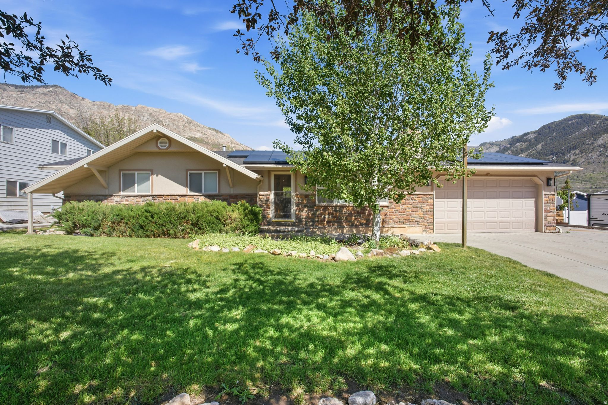 Beautifully updated classic rambler in the heart of North Ogden. Close to parks and canyons with breathtaking mountain and valley views. Fully renovated kitchen, living, dining, and incredibly spacious primary suite with an expertly planned walk-in closet. Bright open concept living with vaulted airy den and attached conditioned shop space. Oversized basement storage room, huge laundry room, and downstairs gathering area. Spacious yard with patio for entertaining. Ample driveway and RV parking, this home offers incredible opportunity, access, and extras. Solar power system generates 15 kw of solar and includes 56 kWh of back-up battery storage. Sellers estimate that solar offsets about $250/month from their Rocky Mountain Power Bill. Home also features a 220 line run to the garage on a 50 amp breaker for Electric Vehicle Charging. Square footage figures are provided as a courtesy estimate only and were obtained from appraisal.  Buyer is advised to obtain an independent measurement.
