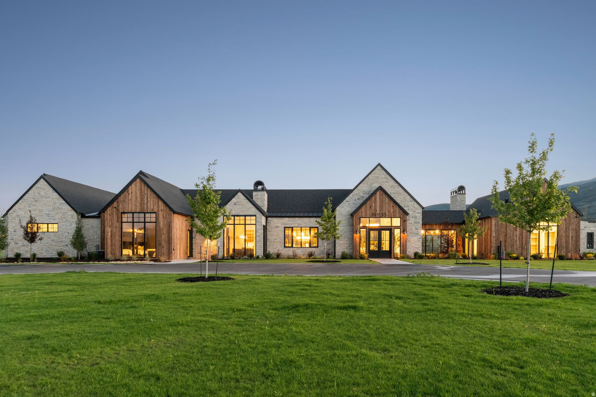 Set on more than four pristine acres beneath the iconic backdrop of Mount Timpanogos, this extraordinary single-level estate redefines modern mountain living. Thoughtfully designed with Scandinavian-inspired farmhouse architecture, the residence blends timeless design, exceptional craftsmanship, and effortless luxury in a setting that offers both privacy and unparalleled access to Utah's finest recreation.  From the moment you step through the grand entry, the home makes an unforgettable first impression. Expansive walls of glass frame breathtaking views of Mount Timpanogos, Deer Creek Reservoir, and the surrounding countryside, while soaring ceilings and an open-concept floor plan fill the home with natural light and create a remarkable sense of scale. Every room has been intentionally designed with generous proportions, refined finishes, and a warm, sophisticated aesthetic.  The heart of the home is a chef's kitchen designed for gathering, featuring premium appliances, abundant workspace, and an oversized dining area ideal for entertaining family and friends. Four spacious ensuite bedrooms provide exceptional comfort, while the private primary wing serves as a true retreat, complete with its own office, secluded patio, spa-inspired bath, and an expansive custom closet.  Designed for year-round entertaining, the outdoor living spaces are every bit as impressive as the interior. A fully equipped outdoor kitchen featuring a premium Traeger smoker, Blackstone griddle, and Chicago-style pizza oven anchors multiple patios, fire pits, and lounge areas, creating countless places to relax, dine, and enjoy Midway's spectacular seasons.  Entertainment extends beyond the home with a state-of-the-art media room and an exceptional detached recreation and wellness lodge that offers far more than additional garage space. In addition to four oversized garage bays, this remarkable space has been thoughtfully designed for recreation, fitness, and relaxation, featuring a golf simulator, fitness studio with sauna and advanced performance equipment, arts and crafts studio, billiards, ping pong, bar, bocce ball, and axe throwing-creating an experience rarely found in a private residence.  The level four-acre property is equally remarkable. Snake Creek gently borders the estate, while a private pickleball court, expansive lawns, RV and boat parking, and abundant open space create endless possibilities. Whether preserving the landscape as a private retreat or imagining future enhancements, the property offers a rare canvas for creating the lifestyle you've always envisioned.  Perfectly positioned for an active mountain lifestyle, the home is less than five minutes from Deer Creek Reservoir for boating and paddleboarding, moments from the world-renowned Provo River, and surrounded by endless hiking, biking, horseback riding, and off-road trails. Historic Midway's charming restaurants, cafs, boutiques, and year-round community events are just minutes away, while Heber Valley Airport is less than eight minutes from the property, offering exceptional convenience for private aviation.  Offered substantially turnkey, the property presents a rare opportunity to step into a thoughtfully curated lifestyle from day one. Combining inspired architecture, exceptional craftsmanship, remarkable amenities, and one of Midway's most desirable locations, this is more than a home-it's a legacy property designed to be enjoyed for generations.