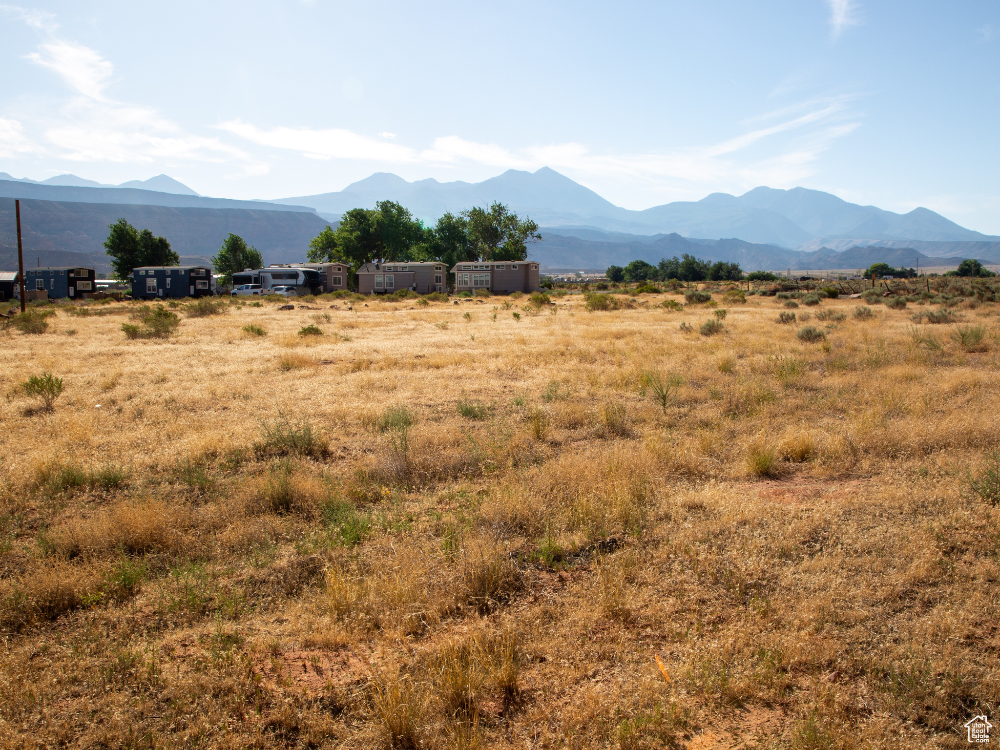 Commercial Development Opportunity  3.99 Acres in San Juan County, Just South of Moab!  Unlock the potential of this 3.99-acre parcel, offering endless commercial development opportunities. Whether you're envisioning your dream RV park, a new business venture, or expanding your current operations, this property provides a strong foundation with an existing 500 sq. ft (Office/Laundry/Restroom/Shower Building), and employee housing hookups already in place.  Located just south of Moab in San Juan County, this versatile property is perfectly positioned for growth. With ample space and flexible potential, the possibilities are wide open-RV park, lodging, service-based business, or recreation-focused enterprise-you decide.  Now is the time to bring your vision to life in one of Utah's most popular and scenic destinations! In addition to the subject property, the adjacent 2.50-acre parcel includes four RV pads and a 4-bedroom, 4-bath residence (2,136 sq ft), offering strong potential for project expansion or phased development. MLS #2126675