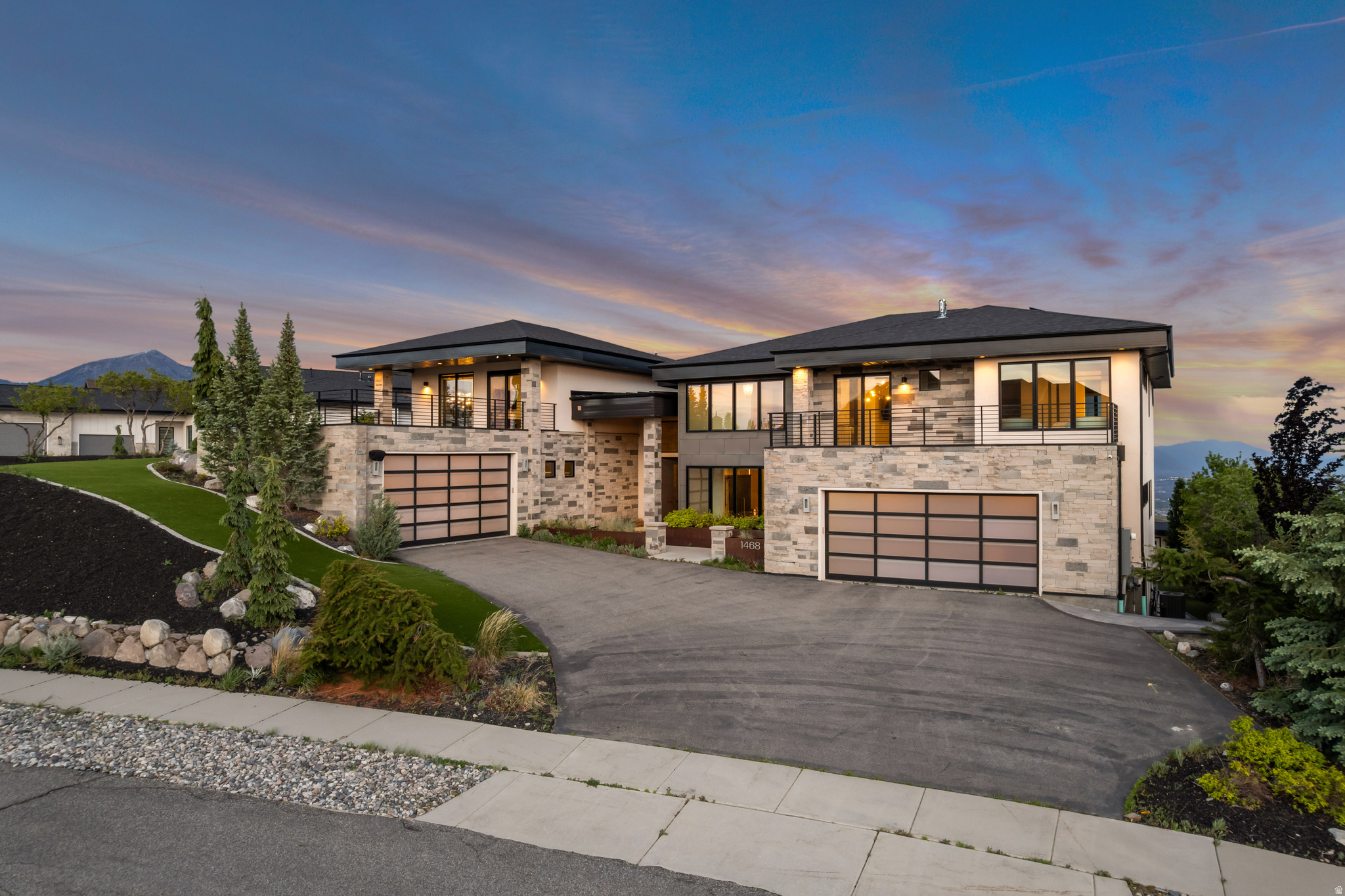Perched at the top of Suncrest, this modern luxury retreat offers unmatched, unobstructed valley and mountain views from every room. Designed by Ezra Lee, the home blends elevated style with everyday convenience across more than 8,000 sq ft of thoughtfully curated living space. Vaulted ceilings and floor-to-ceiling windows flood the interior with natural light, while the gourmet kitchen features dual islands, double ovens, and an expansive pantry, perfect for both cooking and entertaining. The primary suite is a private sanctuary with an oversized walk-in closet, a spa-like bathroom with a sunken tub, a cozy fireplace, and a private deck with its own fire pit. Additional highlights include well-appointed bedrooms/bathrooms, an upper-level living area ideal for a home gym or game room, expansive decks/patios,  a custom bar, a secondary kitchen, a theater room, a home sauna, radiant in-floor heating, a walkout basement, and a four-car oversized garage. Outside, the home features an infinity pool, a full outdoor kitchen with barbecue, two fire pits, illuminated water features, and a putting green, all set against picturesque views. This estate truly has it all in addition to the amazing amenities the Suncrest Community has to offer.  Contact us today to schedule a private tour and experience one of the most exceptional properties in one of the market's most scenic neighborhoods. Buyer/Buyer's Agent to verify all info