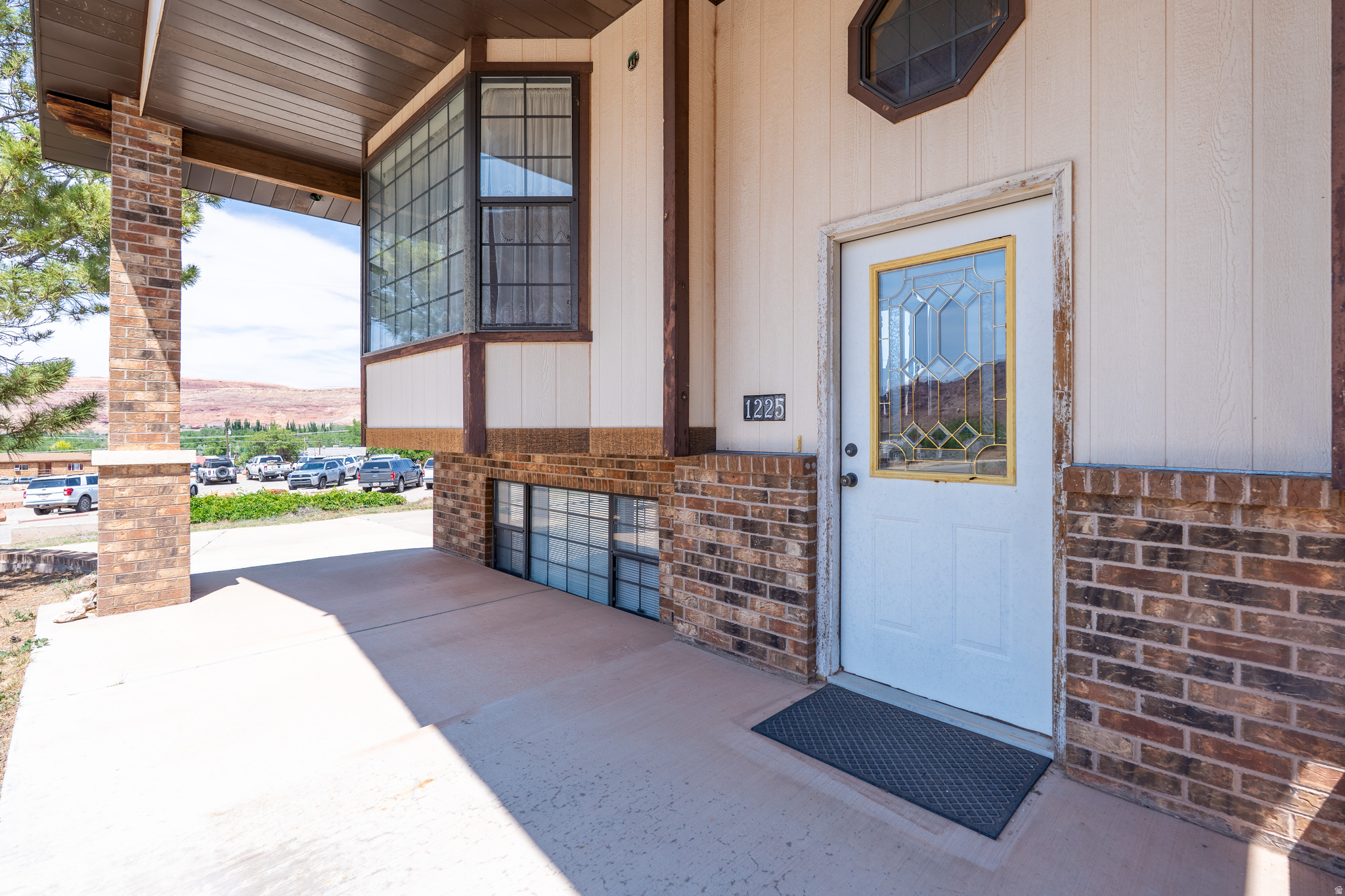 This custom 3-bedroom, 3-bathroom home was built in 1992 by an excellent, well-known local builder and features custom Al Heaton cabinets throughout with lots of parking and room to grow. The property is situated on a quarter-acre lot just off the highway in a less traveled neighborhood in Moab and offers main level living complete with a kitchen, livingroom, and 3 bedrooms including the master suite. The partial daylight basement features an office area, a family room, utility/laundry room, 1 full bath and abundance of storage. This home also has a lot parking options, including covered parking on the south side for main-level access with carport, plus an attached built-in tandem 2 car garage on the north lower side of the lot with an extra large concrete driveway with direct entry to the basement. The daylight basement provides significant flexibility with separate access. Recent updates include some high-priced maintenance items offering long-term peace of mind including a new roof (2024), a replaced main water line (2024), and a new refrigerator (2025). This is a solid, well built home ready for your personal touch with a great layout and space to adapt to your specific needs.  Square footage figures do not match county, buyer is advised to obtain an independent measurement.