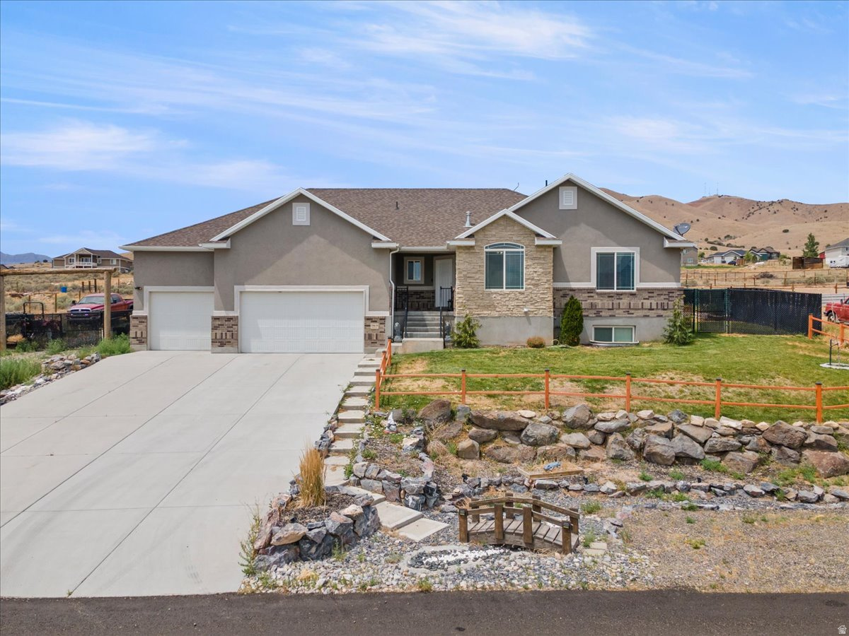 Welcome to this stunning custom-built home, perfectly situated on a picturesque 1-acre lot with breathtaking panoramic views. Offering 5 spacious bedrooms, 3 full bathrooms, and a thoughtfully designed open-concept floor plan, this home blends comfort, style, and functionality. The inviting main living area features soaring vaulted ceilings that create a bright, airy atmosphere, seamlessly connecting the living room, dining area, and gourmet kitchen. The kitchen is beautifully appointed with granite countertops, abundant cabinetry, and plenty of workspace for cooking and entertaining. The spacious primary suite is a private retreat, complete with a luxurious en-suite bathroom featuring a separate soaking tub and walk-in shower, along with a generous walk-in closet. Designed with both everyday living and entertaining in mind, this home offers ample space for family and guests. The impressive 4-car tandem garage provides abundant room for vehicles, recreational toys, storage, or a workshop. Step outside to enjoy the peaceful surroundings, expansive yard, and spectacular views that make this property truly special. With room to roam, exceptional craftsmanship, and an unbeatable setting, this beautiful custom home offers the perfect balance of privacy, comfort, and modern living.   Square footage figures are provided as a courtesy estimate only and were obtained from County Records.  Buyer is advised to obtain an independent measurement.
