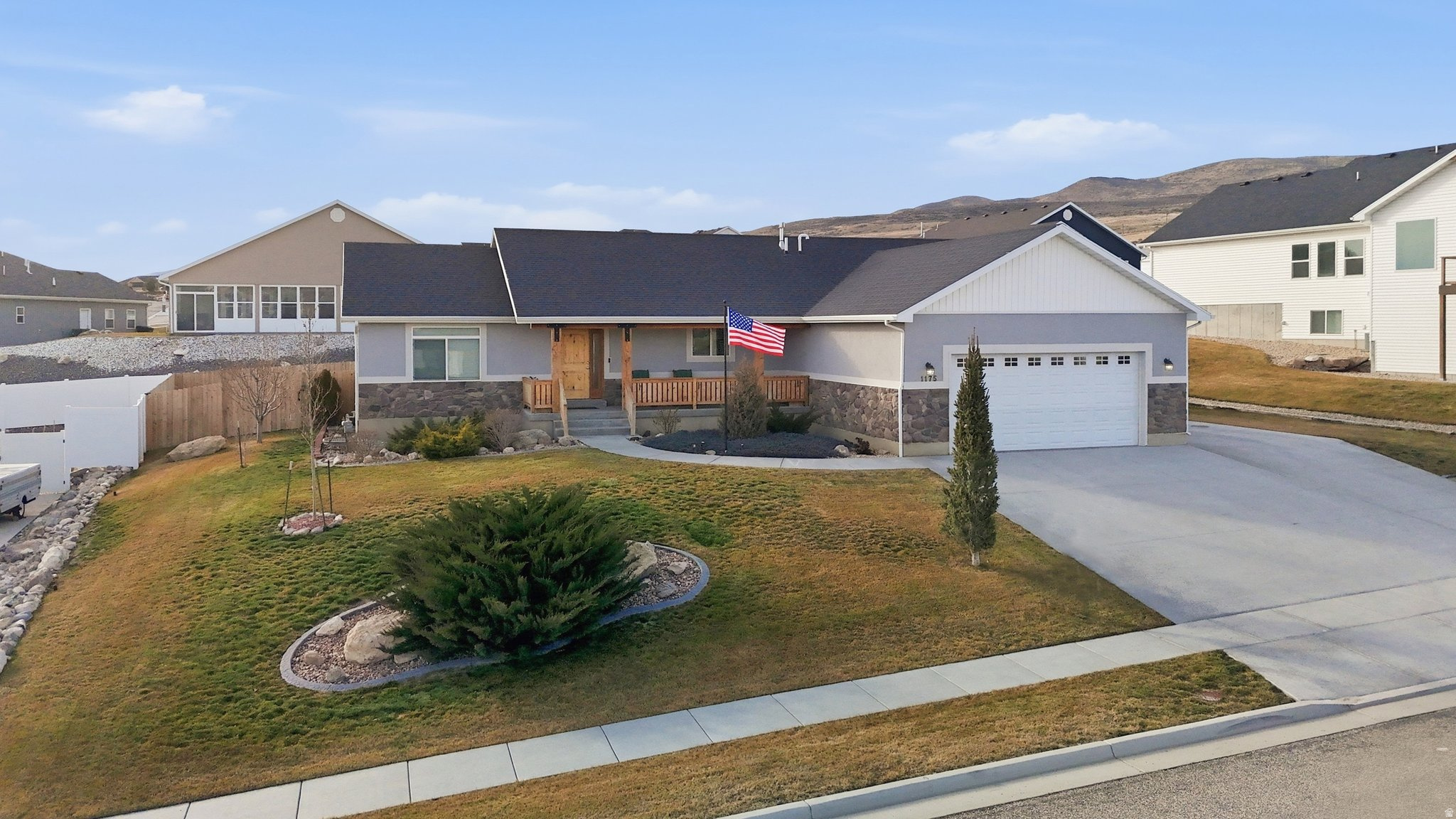 Beautiful custom ranch-style home perched on the northwest bench of Tremonton, Utah, capturing breathtaking valley views and unforgettable sunrises. Nestled at the foothills of the mountains, this property offers the perfect blend of scenic beauty, small-town charm, and everyday convenience. Enjoy peaceful mornings from the inviting front porch overlooking the mountain range and Tremonton City below. Located just minutes from the heart of town, you're approximately 2 miles from Tremonton's Main Street amenities, 1 mile from the hospital, and about 2 miles from Bear River High School and the Box Elder County Fairgrounds-home to rodeos, truck pulls, and year-round community events. This fully finished home offers exceptional space and versatility with 7 bedrooms and 3 full bathrooms. The main level features 3 bedrooms and 2 full baths, while the basement includes 4 additional bedrooms, a full bath, and a spacious family room complete with a wet bar-ideal for entertaining, movie nights, or multi-generational living. Situated in a quiet, desirable subdivision, the beautifully landscaped yard is thoughtfully designed and fully fenced with cedar fencing. Features include a full sprinkler system hooked to secondary irrigation water for cost savings, mature evergreens, a sycamore tree, Pacific Sunset maple, and fruit trees including plum, peach, cherry, and apple-creating a private, picturesque setting. With its elevated bench location, stunning views, functional layout, and prime proximity to town amenities, this home truly offers the best of Tremonton living. Don't miss the 3D tour and video tour. Buyer to verify all information.