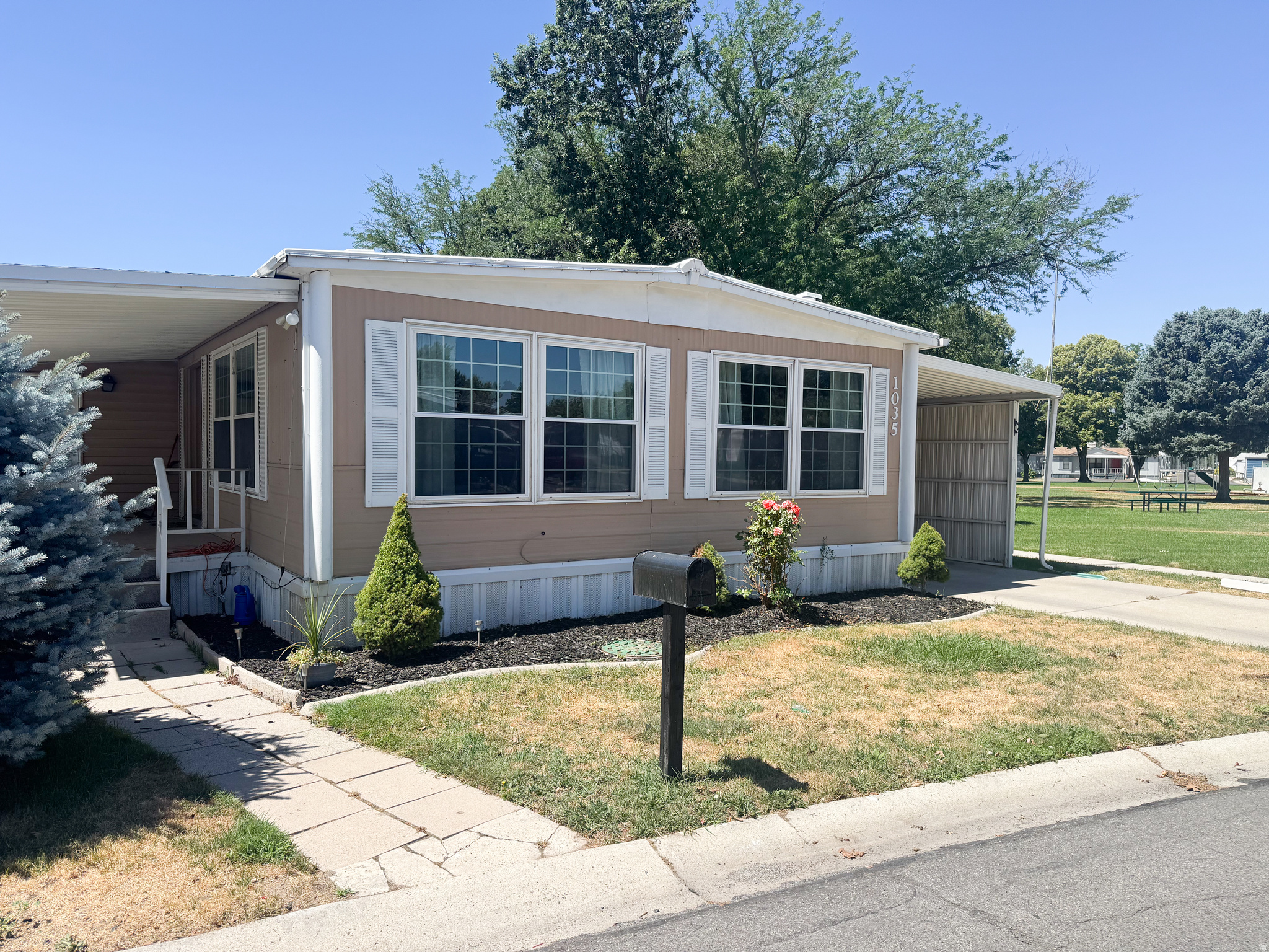 Some homes simply give you a place to live. Others feel like a little world of their own. Tucked into what may just be the best spot in the entire community, this beautifully remodeled 3-bedroom, 2-bath home offers nearly 1,400 square feet of warmth, comfort, and everyday magic. Step outside and you'll find something truly special: open green space right next door, creating the feeling of an extended yard and a little extra room to breathe. Inside, the story continues with thoughtful updates throughout, including newer kitchen cabinets, quartz countertops, updated windows, LED lighting, beautiful flooring, and a redone roof. Full sprinklers help keep the outdoor spaces lush, while the home's inviting layout offers room to gather, retreat, create, and grow. It's the kind of place where mornings feel quieter, evenings linger a little longer, and home feels like more than an address. With a wonderful park community around you and one of its most special lots beneath you, this isn't just a home you come back to at the end of the day. It's the kind of place you find yourself missing before you've even left. Square footage figures are provided as a courtesy estimate only and were obtained from MLS.  Buyer is advised to obtain an independent measurement.