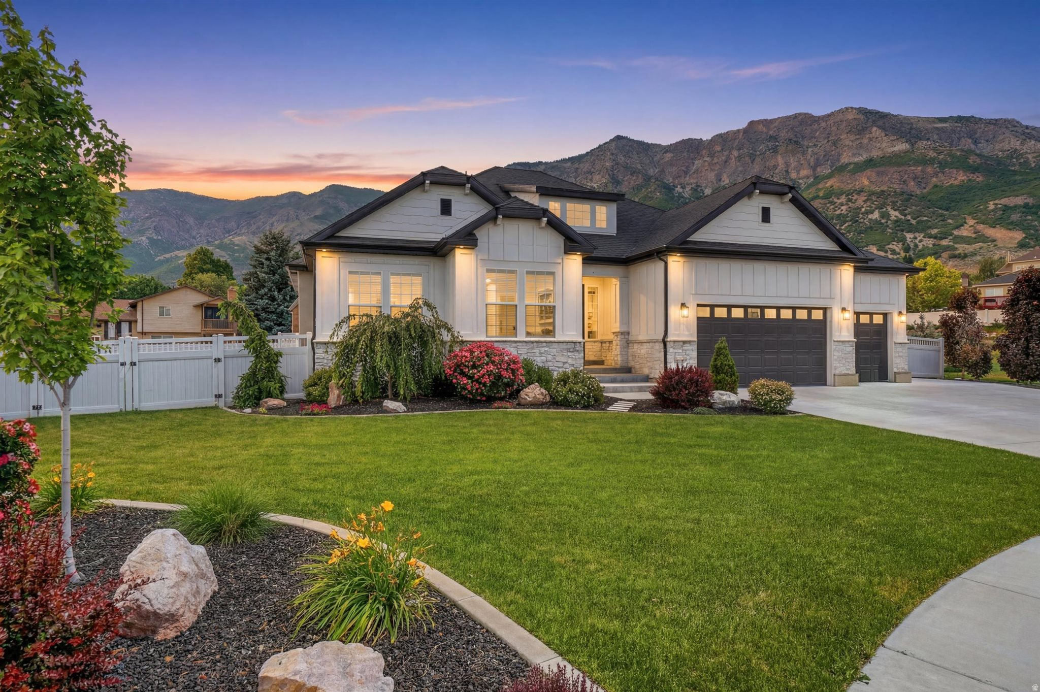 Bright, open and inviting home with space, upgrades and beautiful mountain views!  The upgraded kitchen features maple cabinets, quartz countertops, LVP flooring, double ovens and a gas stove, perfect for cooking and gathering.  The vaulted ceilings and cozy fireplace create a warm and elegant feel throughout the main living space.  The spacious primary suite offers vaulted ceilings, a grand bathroom with a tile shower, 6-foot jetted tub and a large walk-in closet.  Generous bedroom sizes give everyone room to spread out.  The basement is stubbed for a kitchen, offering great potential for a future mother-in-law apartment or additional living space.  This home is packed with extras, including LED lighting, water softener, surround sound wiring upstairs and electrical prep for a generator.  The oversized 3-car garage features extra depth and height, plus 240 power, perfect for tools, hobbies, or electric vehicles.  There's also RV parking for all your Utah adventures.   Step outside to enjoy a covered deck, firepit and a peaceful river-style waterfall feature, creating the perfect backyard retreat.  Located in a quiet cul-de-sac, this home offers easy access to hiking and biking trails, mountain views and quick freeway access for commuting.