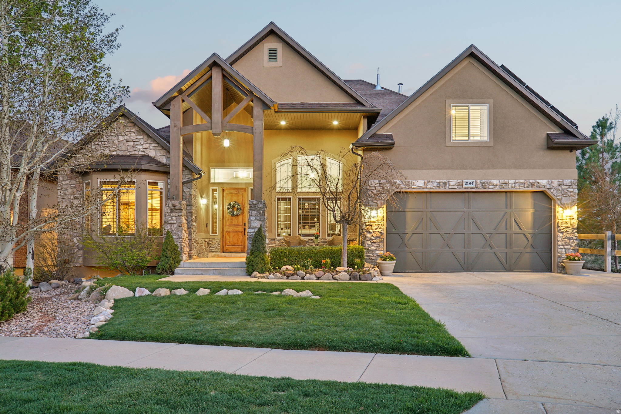 Experience "top of the world" living in this stunning executive home, perfectly situated within the Suncrest community to capture unobstructed, majestic views of Lone Peak, Utah Lake, and the Timpanogos Range. Step inside to soaring vaulted ceilings and an open-concept great room anchored by a floor-to-ceiling stacked stone fireplace and oversized windows that frame the valley below. The main-floor primary suite is a true retreat, featuring its own cozy fireplace and breathtaking views. Enjoy a serene morning routine in the light filled en-suite, featuring the ultimate comfort of heated flooring. The fully finished walk-out basement is a standout feature, offering an in-law suite complete with a second gourmet kitchen, dining area, two spacious bedrooms, media/entertaining space, and a laundry room-perfect for multi-generational living or a high-end guest haven. Enjoy quiet evenings in the outdoor hot tub on the oversized deck, or world-class Eagle Crest hiking and biking trails. With a solar array covering nearly all power costs, this home offers luxury living with a practical, energy-efficient edge. Come see all this home has to offer. Floor to ceiling renovations (including paint, flooring, stairs, baseboards, refrigerators, cooktops, indoor and outdoor lighting, bathroom fixtures, ceiling fans, window treatments) completed within the last two years. Pre-wired surround sound system with 7 speakers in the family room, 2 speakers in the formal dining room, and speakers in the backyard. Primary bedroom is also pre-wired for 6 speakers. Primary suite on main floor and 3 bedrooms on upper floor. Large 450+ sq ft of additional cold storage. Three-car garage with workbench, EV charging outlets, and an oversized driveway. Energy Efficiency - 42 panel solar system and all window panes replaced in 2025.