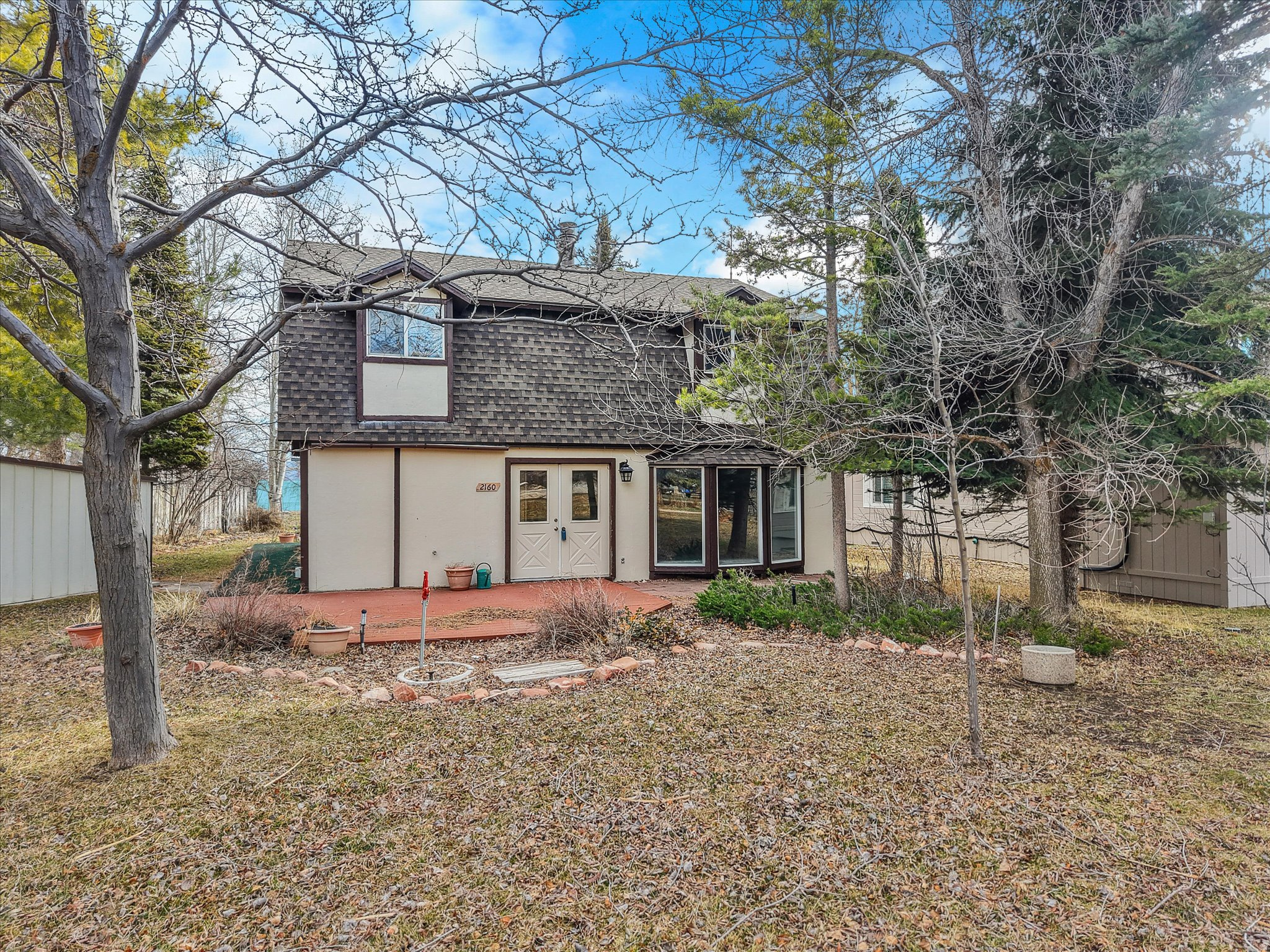 Located in the exclusive, lakefront gated community of Lakota Estates, this 3-bedroom, 2-bath home offers 2,048 square feet of living space, combining comfort and privacy. A spacious deck off the kitchen and dining area showcases beautiful lake views and is ideal for entertaining. Just steps away is a fire pit that creates the perfect gathering space for a large group. Enjoy easy access to the beach by foot or drive down to set up your cabana with plenty of room for many people to enjoy the lake. The property also includes three storage sheds for added convenience. There is a space to store a boat or RV. Lakota Estates is known for its peaceful atmosphere with no short-term rentals allowed, creating a quiet, residential environment that's increasingly rare in the Bear Lake area. Whether you're looking for a full-time residence or a private second home, this community provides the serenity and security buyers are seeking. One of the standout features of this property is the open space directly behind the home, giving it an expansive feel and protecting your view corridor to the lake. Instead of backing to another home, you'll enjoy unobstructed scenery and a sense of openness that enhances both everyday living and entertaining. The lake views paired with the gated setting make this property especially appealing. If location, privacy, and long-term value are at the top of your list, this Lakota Estates home delivers the ideal Bear Lake lifestyle.