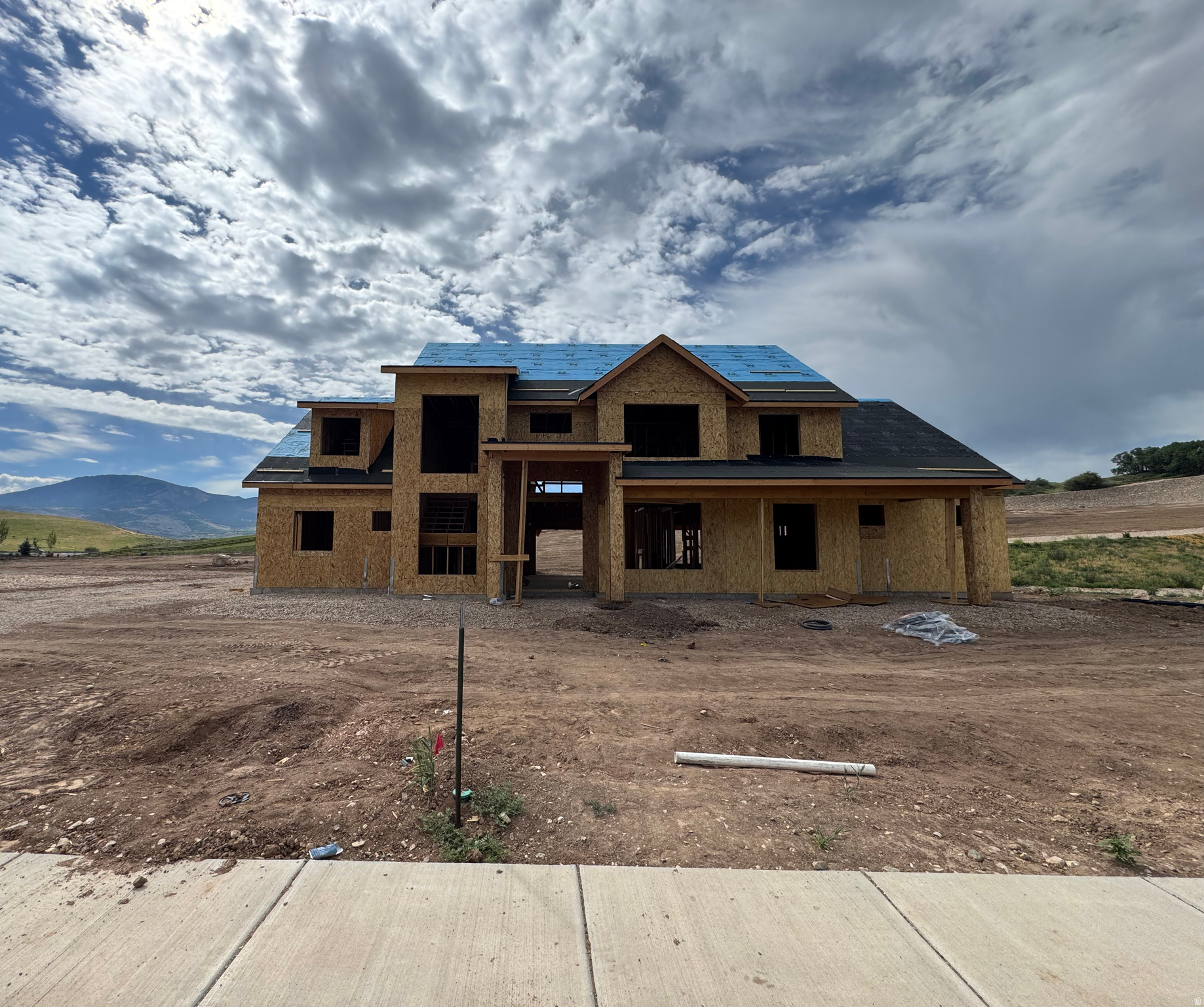 Here's something new! Experience mountain living without compromise in this exceptional custom home, thoughtfully designed to capture breathtaking panoramic views from nearly every room. Perfectly positioned just below Snowbasin Resort, just minutes from Pineview Reservoir, and a short 40-minute drive the the Salt Lake City International Airport, this remarkable home offers year-round recreation and stunning scenery. Set on a fully usable .57-acre lot, the property offers endless possibilities with ample space for a pool, pickleball court, detached garage, or additional outdoor amenities. The distinctive floor plan was created for both everyday comfort and effortless entertaining. Everything you need is located on the main level. The main floor features expansive living spaces with seamless indoor/outdoor flow through oversized sliding glass doors, including a dramatic 3-panel slider in the great room and an additional slider off the kitchen. A spacious covered patio provides the perfect setting to relax, entertain, and take in the surrounding scenery. The backyard is ideally suited for a future pool, while the crawl space offers convenient storage for pool equipment. The beautifully appointed kitchen is complemented by a spacious butler's pantry with a second refrigerator, sink, dishwasher, and second oven, providing exceptional prep and entertaining space. The gorgeous primary suite features double vanities, wet room with dual shower heads and freestanding tub, walk-in shower and soaker tub, and walk-in closet with laundry hookups. Upstairs, you'll find generously sized bedrooms and a versatile bonus room with a kitchenette, while the absence of a basement allows for an efficient and highly functional layout. The oversized garage includes a convenient half bath. An added advantage- there's still time to personalize the home's finishes and select colors to reflect your own style. A rare opportunity to own a truly custom mountain retreat in one of Northern Utah's most sought-after locations. Sq. footage per plans. Property facts are provided as a courtesy; Buyer to verify all information.