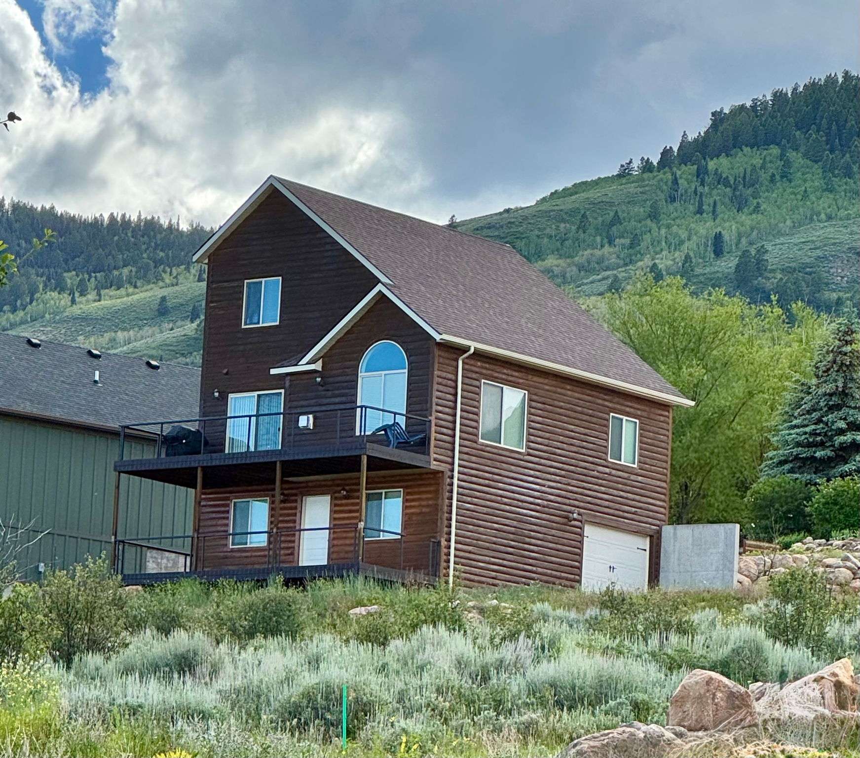 Bear Lake Retreat with Unmatched Views! Nestled in the desirable Bear Lake West community, this fully furnished mountain getaway offers breathtaking end-to-end views of Bear Lake and direct access to snowmobile and ATV trails right from your doorstep. Designed for gathering and entertaining, this spacious four-level home features convenient main-floor living, including the primary bedroom, laundry, and an open-concept kitchen with granite countertops. Multiple living areas provide plenty of room for family and guests, with a family room in the basement with a walkout to covered basement deck and another basement with a gameroom. The lot has plenty of room on the North side to access garage and possibly build a detached garage. This creates the perfect setting to relax and take in the stunning lake and mountain scenery. Whether you're looking for a year-round residence, vacation home, or investment property, this turnkey retreat is ready for you to start making Bear Lake memories.