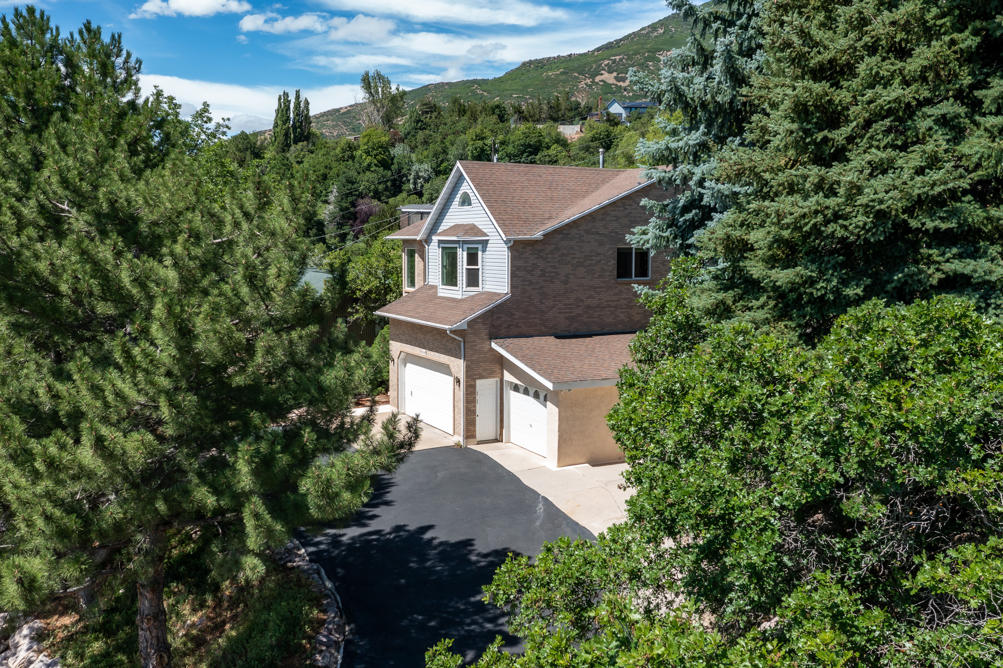 Located in the desirable Uintah Highlands, this beautifully maintained home offers quick access to hiking and mountain biking trails with panoramic mountain and valley views. The original owners have meticulously cared for the home. The remodeled kitchen features granite countertops, double ovens, and a new refrigerator. Spacious family room with new flooring and  Additional updates include remodeled bathrooms and new high UV/rain resistant windows throughout the home. Spacious family room with new flooring and energy-efficient recirculating fireplace. Enjoy the wrap-around deck overlooking a peaceful koi lily pond and private, mature backyard. The oversized 3-car garage includes an EV charging outlet, plus abundant extra parking.
