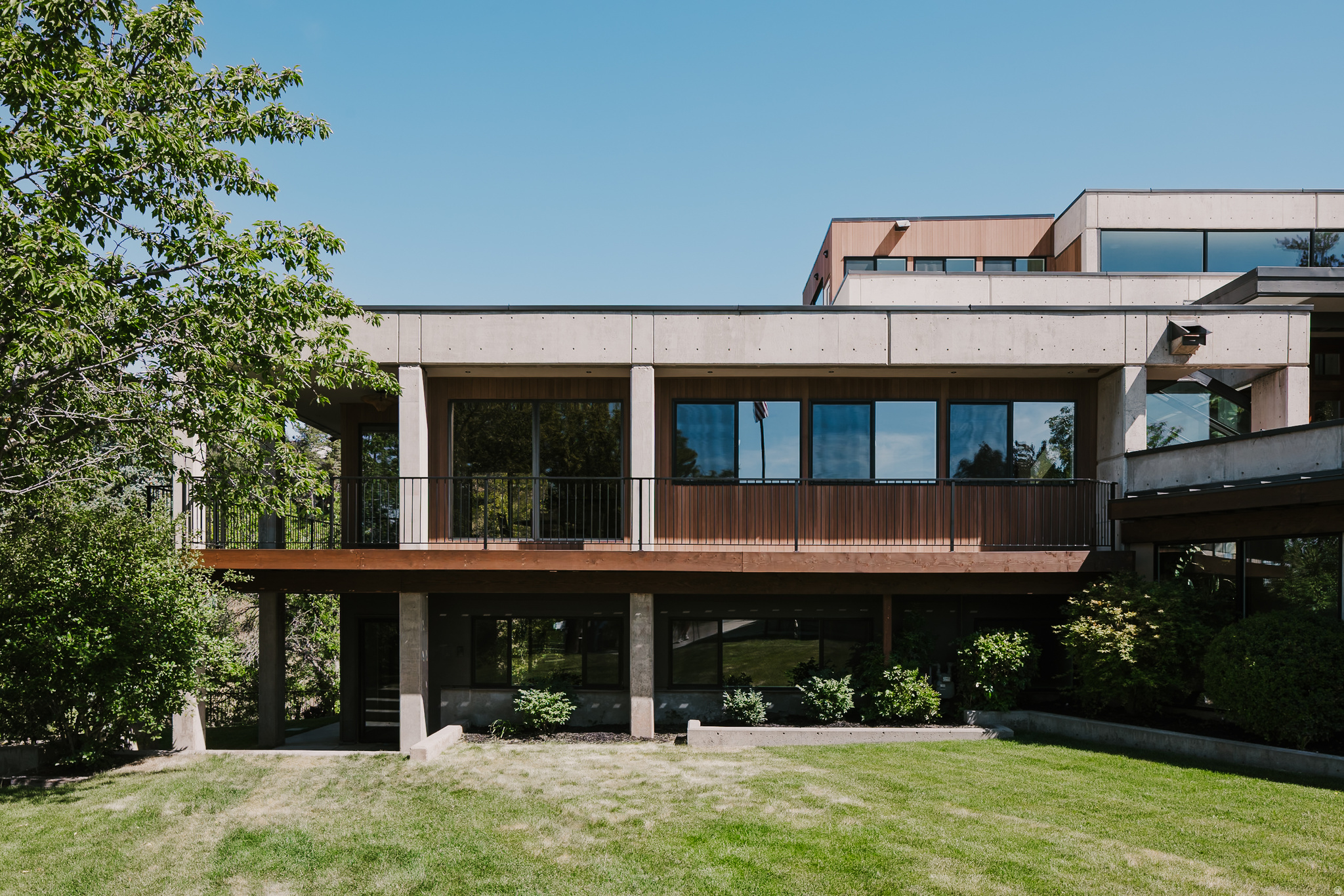 Perched on a breathtaking mountainside lot in Federal Heights, this stunning contemporary home designed by W.N. Cooper makes a bold architectural statement. The striking blend of concrete, soaring glass walls, warm wood accents, and organic finishes such as natural stone and plaster, create a home that feels both dramatic while also feeling warm and inviting. Tucked away in a quiet .68 acre cul-de-sac lot backing the wooded Dry Creek Canyon, the setting offers peaceful mountain views while simultaneously offering incredible city views of downtown Salt lake City and the Capitol.  The spacious primary suite offers its own secluded escape with an en suite bath surrounded by a running water feature that makes it feel and sound like your own personal indoor/outdoor retreat. With serene outdoor access this primary suite is designed to immerse you in the surrounding nature.  Each of the three additional bedrooms includes its own attached bathroom, offering comfort and privacy throughout. The fifth bedroom can be used as a bedroom or is currently designed for use as an office.  The upper level of the home has 360 views with windows in every direction and multiple decks around the home capture every city and nature view. This is certainly a one of a kind home and a must see.  Square footage figures are provided as a courtesy estimate only and were obtained from independent measurement.  Buyer is advised to obtain an independent measurement. Buyer to verify all listing details.
