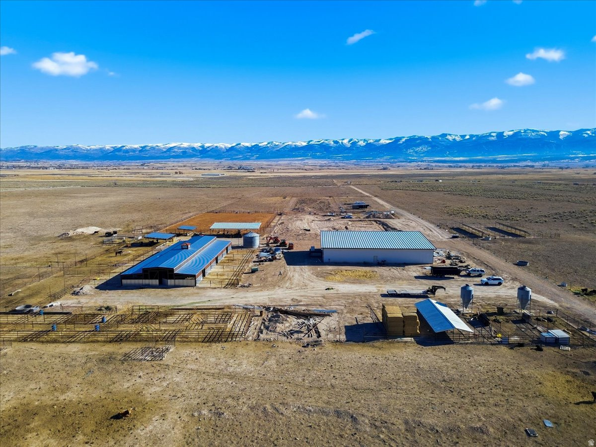 Stunning 127-acre ranch offering exceptional infrastructure, functionality, and natural beauty, ideal for equestrian, agricultural, or mixed-use operations. The property features brand-new perimeter and cross-fencing for security and flexibility. Comes with a well and 1 water right for the well.  A newly built 6,000 sq ft shop (2025) includes five large bays, each with its own garage door and a bathroom. The impressive 6,888 sq ft stall barn offers 12 oversized stalls (23x16) with 23x30 turnouts, automatic frost-free water, plus 10 additional stalls, multiple animal pens, and large turnouts. A professional 150x250 roping arena includes covered boxes and a sprinkler system to maintain ideal footing. The property is enhanced by over 20 shade trees, all on a dedicated sprinkler system, with an additional system in place for future yard grass.  The ranch is equipped with a complete solar system and batteries capable of powering the entire property and allowing for expansion. A completed perc test is already in place for septic installation. With wide-open spaces and beautiful views, this ranch offers endless possibilities, whether for equestrian use, agriculture, or a peaceful retreat.  This  includes two Parcel Numbers:  0000025564X that is 22 acres and 0000025565 that is 105 acres for a total of 127 acres.