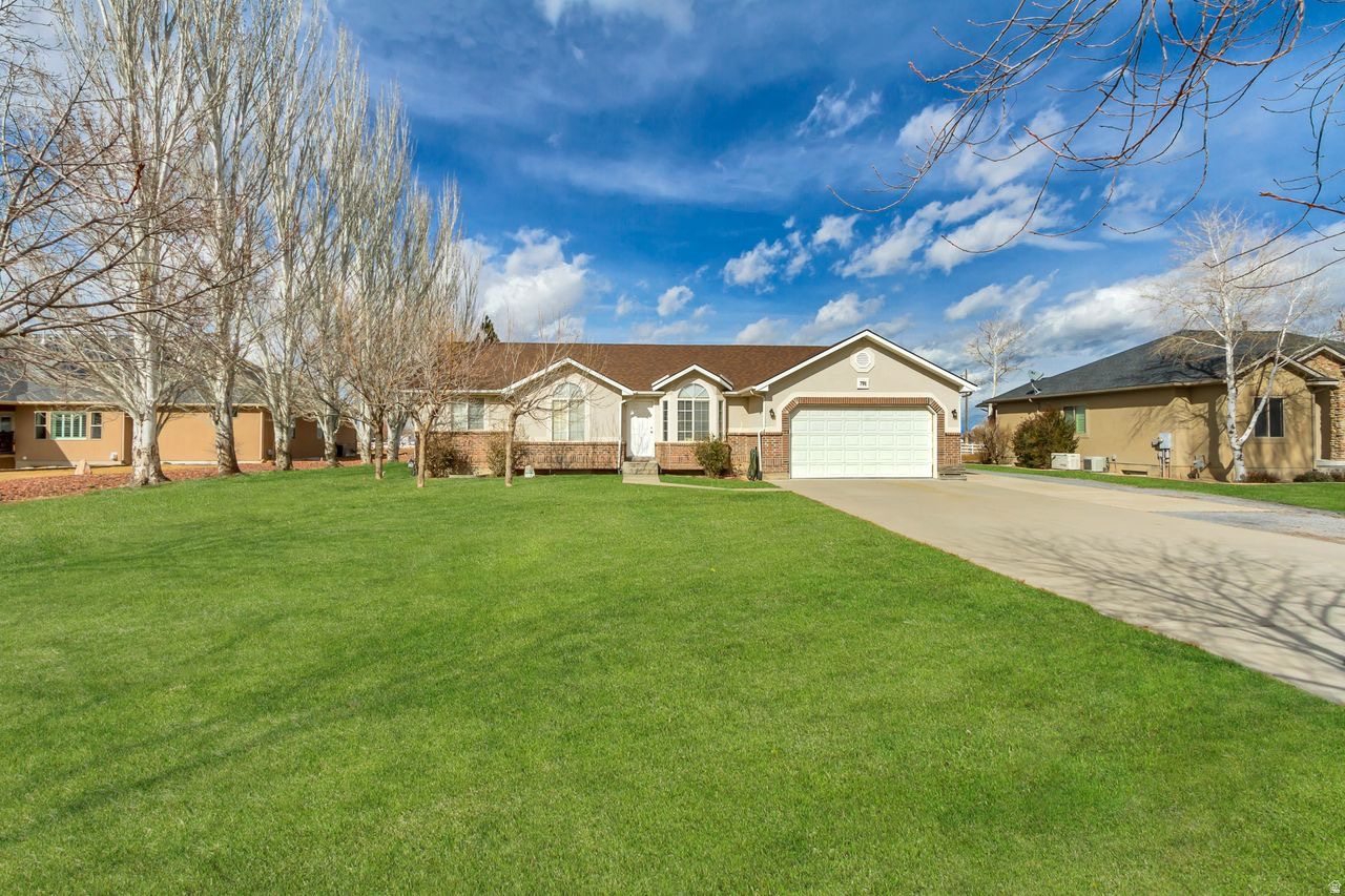 $5,000 BUYER INCENTIVE AT CLOSING TO USE FOR WHATEVER THE BUYER FEELS NECESSARY.   MUST SEE INSIDE!   What an Incredible price on this Beautiful Rambler on .56 Acres!  This home comes with a NEW 26 X 30 SHOP AND A NEW 15 X 24 CARPORT for ALL YOUR TOYS AND PROJECTS.  Enjoy Serenity on your own half acre with large trees and plenty of parking and you are only 20 minutes from the Stansbury Mountain range with camping, hiking and fishing. Clean-Clean-Clean. A NEW Roof, NEW Hot Water Heater and NEW HVAC system installed. NEW counter tops, NEW GAS Range and Backsplash in your open kitchen. NEW fence around your backyard. NEW Shower in the master bath. NEW Front Door and Back patio doors and so much more. Only 35 minutes to the Salt Lake City International Airport. The Basement is 90% finished with 2 more bedrooms, a Full bathroom and a Huge Family Room to enjoy a movie or games on those colder days. The garage and shop are both wired with 220 power. Stunning Hardwood floors in the kitchen and hallway have been refinished. Lots of Natural light. Fully insulated garage with multiple outlets. Tons of storage. Living room has natural gas available for a fireplace. Polyurethane insulation throughout and manabloc plumbing. This TURN-KEY home is the perfect place to make new memories for the holidays or have a quiet BBQ in the backyard.  Don't let this home pass you by.