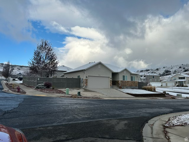 Price Reduced!! Discover comfort, privacy, and stunning scenery in this beautifully maintained home perched on a prime corner lot with no neighbors on three sides. Enjoy beautiful views of the lake, mountain, and the temple, all while being minutes from major conveniences. The fully fenced yard is ideal for relaxation and functionality, featuring RV parking with backyard access, a 220V outlet for RV or workshop needs, and a composite deck attached to a complete patio with a new oversized awning.  The landscaping features a desert-friendly front yard and a lush backyard filled with mature trees and a charming doghouse. Inside, the home offers modern updates, including granite countertops in the kitchen and bathrooms, a new kitchen backsplash, double-pane windows, and a new sliding glass door with built-in blinds. Additional upgrades include a newer water heater, water softener, and kitchen water filter.  The garage features a new garage door spring and opener, a large garage door, and energy efficiency stands out with R-49 blown-in attic insulation and R-15 blown-in exterior wall insulation.  The basement offers excellent potential with insulation and framing completed for two bedrooms, space for a possible third room, and initial electrical work, including outlets for a freezer and additional power needs. Strong window-well covers add safety and peace of mind.  Sq footage taken from county records. Buyer to verify all information.